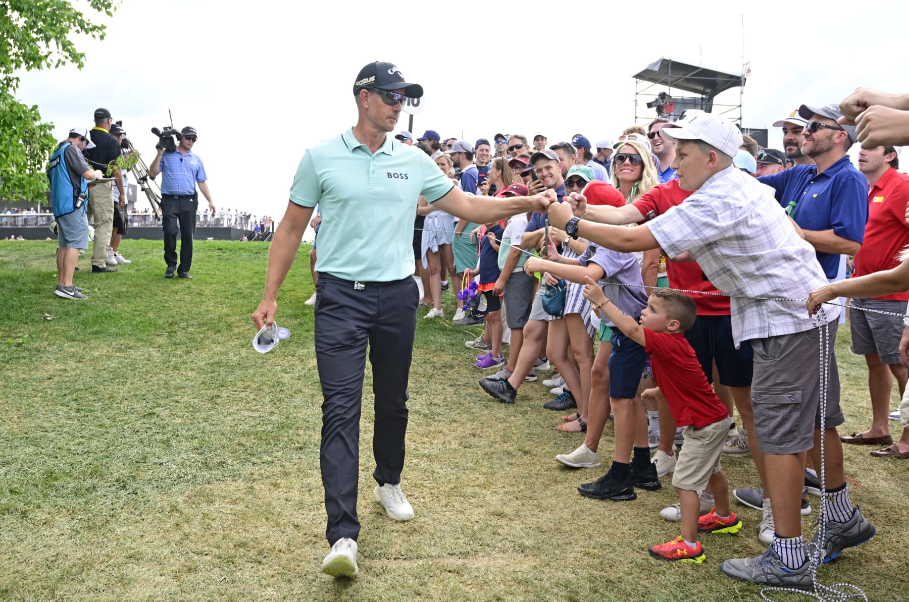 BEDMINSTER, NEW JERSEY - JULY 31: Henrik Stenson of Majesticks GC fist bumps a young fan on his way to the 11th tee during day three of the LIV Golf Invitational - Bedminster at Trump National Golf Club Bedminster on July 31, 2022 in Bedminster, New Jersey. (Photo by Charles Laberge/LIV Golf via Getty Images)
