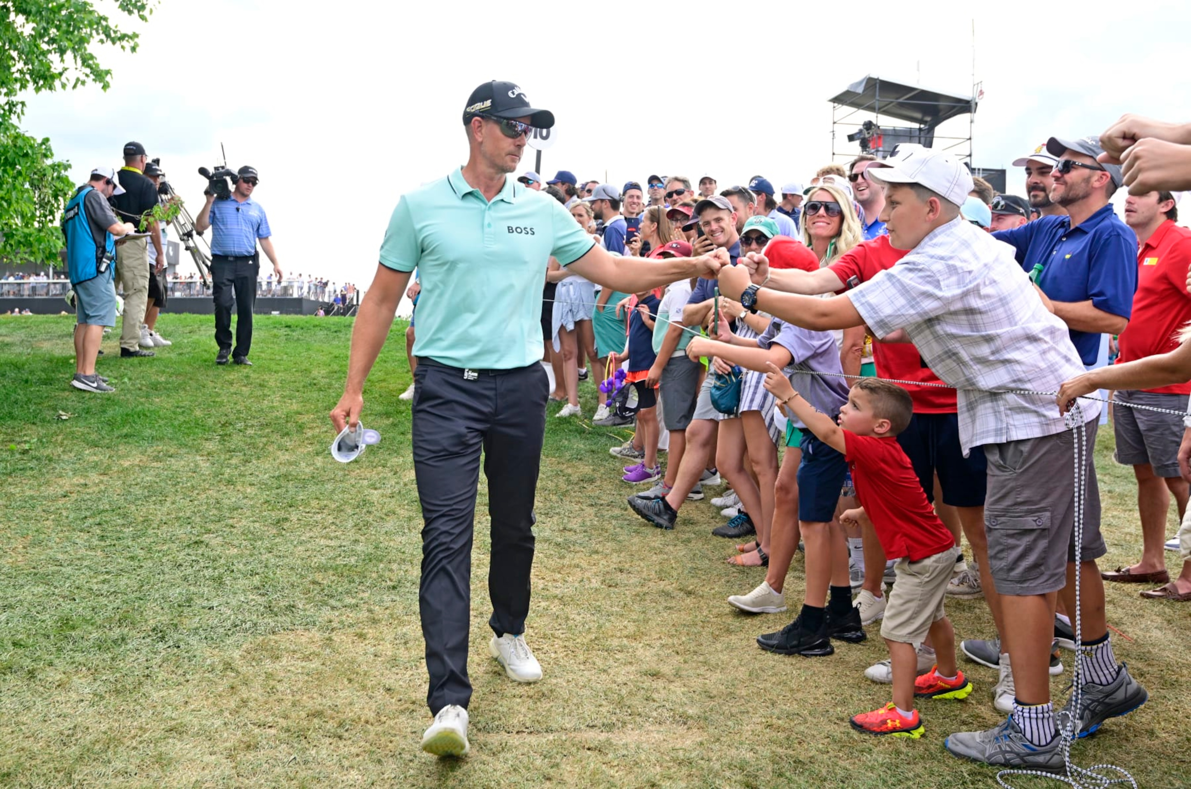 BEDMINSTER, NEW JERSEY - JULY 31: Henrik Stenson of Majesticks GC fist bumps a young fan on his way to the 11th tee during day three of the LIV Golf Invitational - Bedminster at Trump National Golf Club Bedminster on July 31, 2022 in Bedminster, New Jersey. (Photo by Charles Laberge/LIV Golf via Getty Images) BEDMINSTER, NEW JERSEY - JULY 31: Henrik Stenson of Majesticks GC fist bumps a young fan on his way to the 11th tee during day three of the LIV Golf Invitational - Bedminster at Trump National Golf Club Bedminster on July 31, 2022 in Bedminster, New Jersey. (Photo by Charles Laberge/LIV Golf via Getty Images)