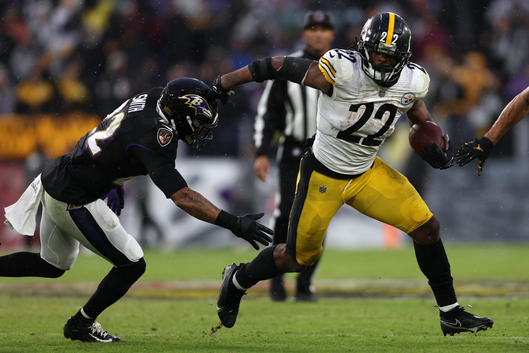 BALTIMORE, MARYLAND - JANUARY 09: Najee Harris #22 of the Pittsburgh Steelers runs the ball while being chased by Jimmy Smith #22 of the Baltimore Ravens in over time at M&T Bank Stadium on January 09, 2022 in Baltimore, Maryland. (Photo by Patrick Smith/Getty Images)