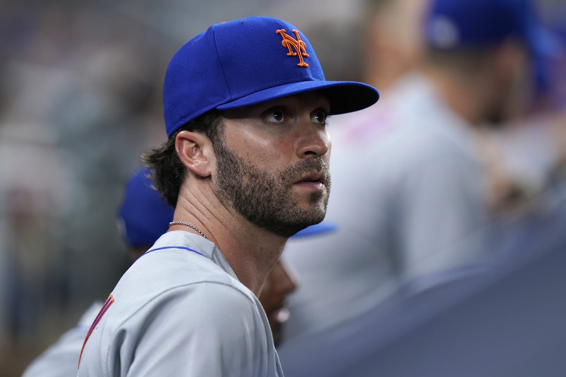 New York Mets' Tyler Naquin looks out from the dugout during the fifth inning of a baseball game against the Miami Marlins, Friday, July 29, 2022, in Miami. New York acquired the left-handed-hitting outfielder and lefty reliever Phillip Diehl from on Thursday night in a deal for two teenage minor leaguers, outfielder Hector Rodríguez and right-hander Jose Acuña. (AP Photo/Wilfredo Lee)