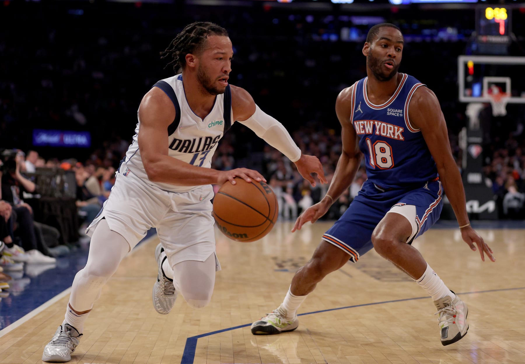 NEW YORK, NEW YORK - JANUARY 12:  Jalen Brunson #13 of the Dallas Mavericks drives around Alec Burks #18 of the New York Knicks in the first half at Madison Square Garden on January 12, 2022 in New York City. NOTE TO USER: User expressly acknowledges and agrees that, by downloading and or using this photograph, User is consenting to the terms and conditions of the Getty Images License Agreement. (Photo by Elsa/Getty Images)