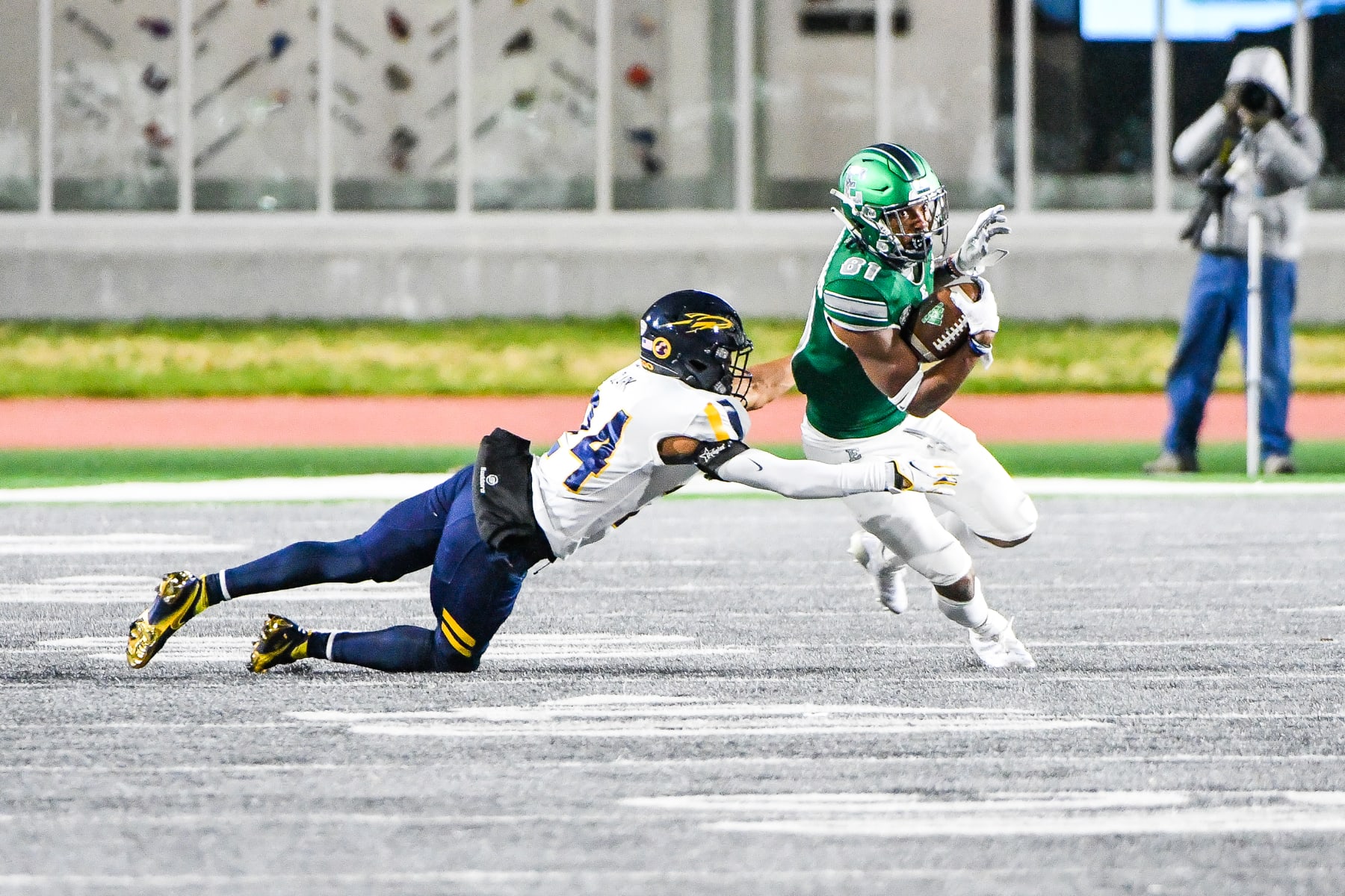 YPSILANTI, MI - NOVEMBER 18: Eastern Michigan Eagles wide receiver Quian Williams (81) makes a catch and tries to escape the tackle by Toledo Rockets cornerback Justin Clark (24) during the Eastern Michigan Eagles vs Toledo Rockets game on Wednesday November 18, 2020 at Rynearson Stadium in Ypsilanti, MI (Photo by Steven King/Icon Sportswire via Getty Images)