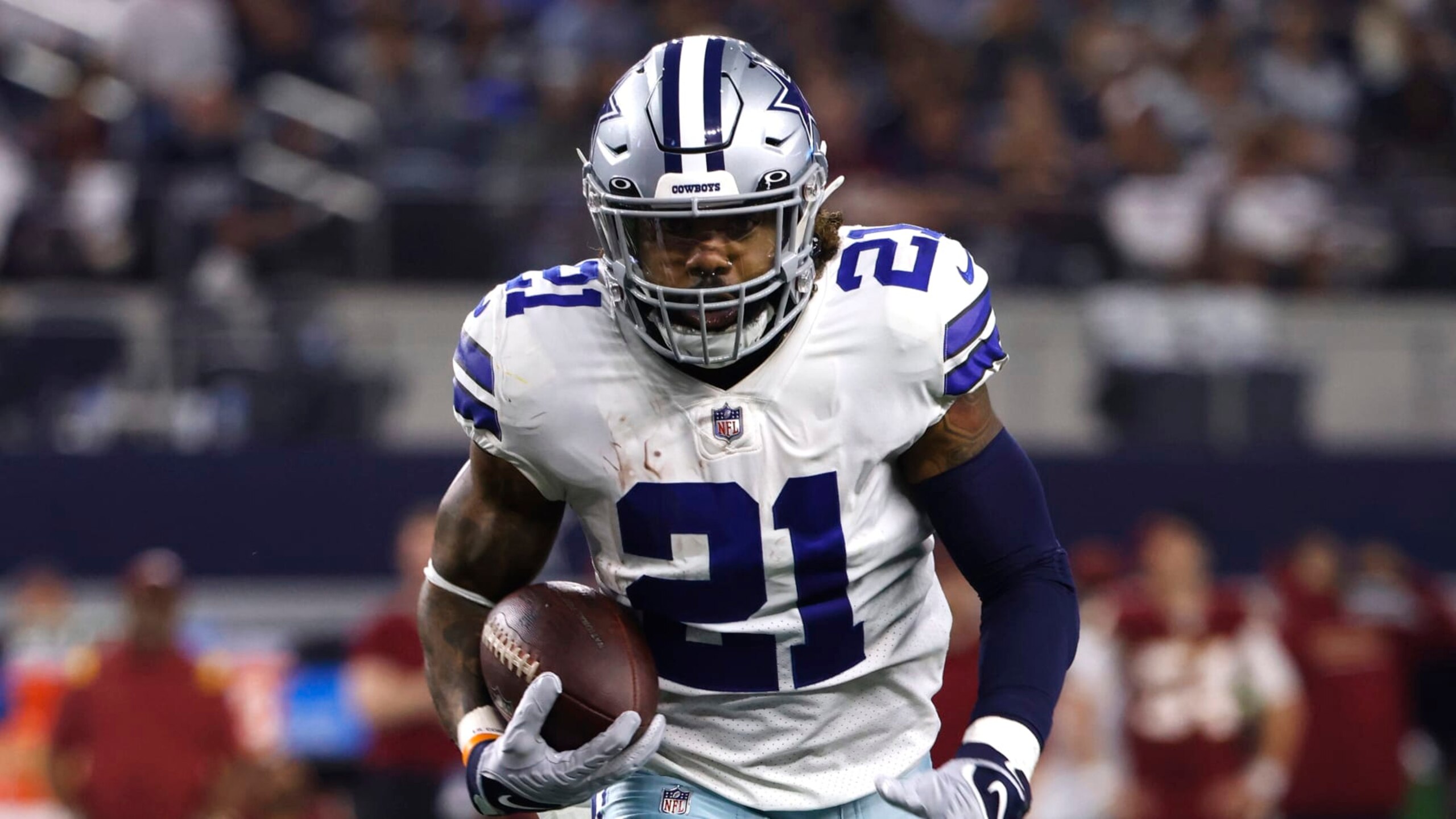 Dallas Cowboys running back Ezekiel Elliott (21) runs for a touchdown against the Washington Football Team in an NFL football game in Arlington, Texas, Sunday, Dec. 26, 2021. (AP Photo/Ron Jenkins)