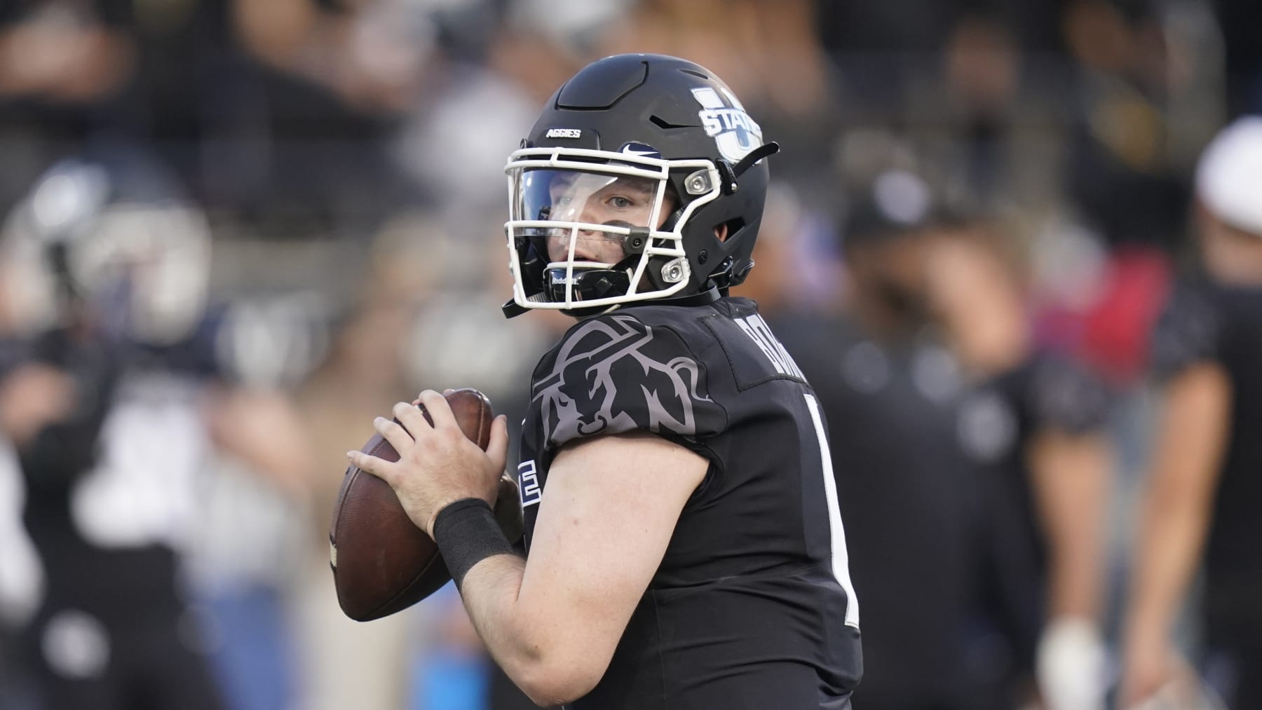 Utah State quarterback Logan Bonner (1) warms up during an NCAA college football game against BYU Friday, Oct. 1, 2021, in Logan, Utah. (AP Photo/Rick Bowmer)