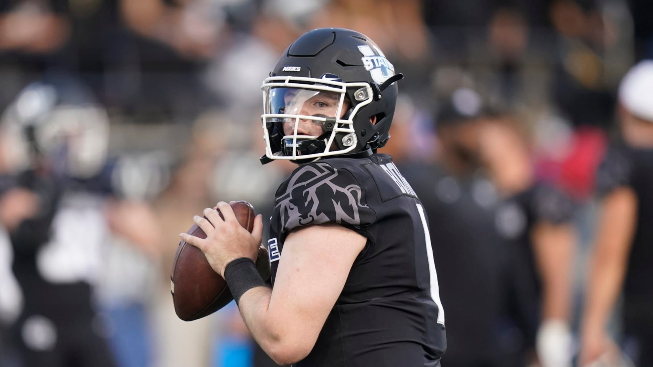 Utah State quarterback Logan Bonner (1) warms up during an NCAA college football game against BYU Friday, Oct. 1, 2021, in Logan, Utah. (AP Photo/Rick Bowmer)