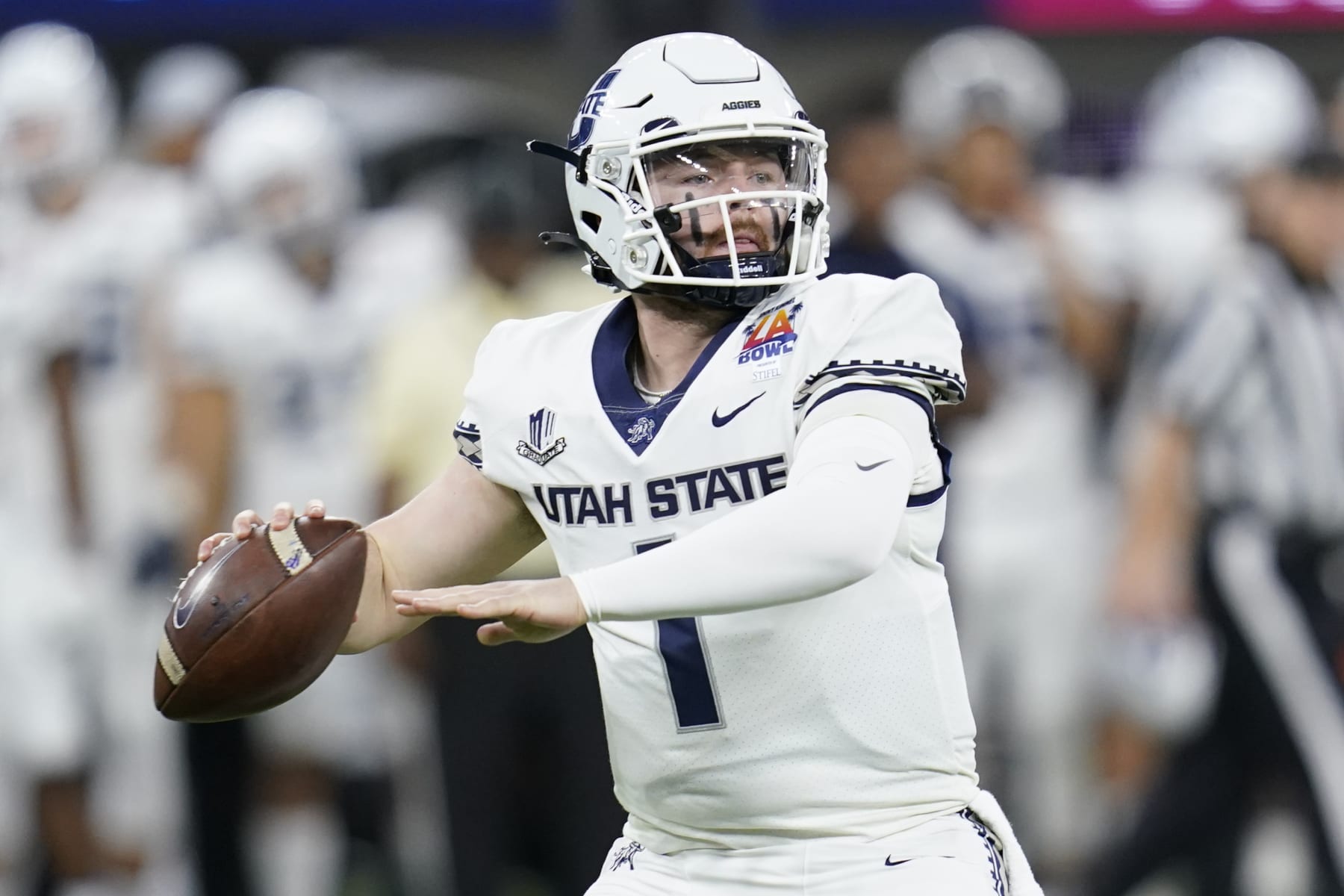 Utah State quarterback Logan Bonner (1) looks to throw during the first half of the LA Bowl NCAA college football game against Oregon State in Inglewood, Calif., Saturday, Dec. 18, 2021. (AP Photo/Ashley Landis)