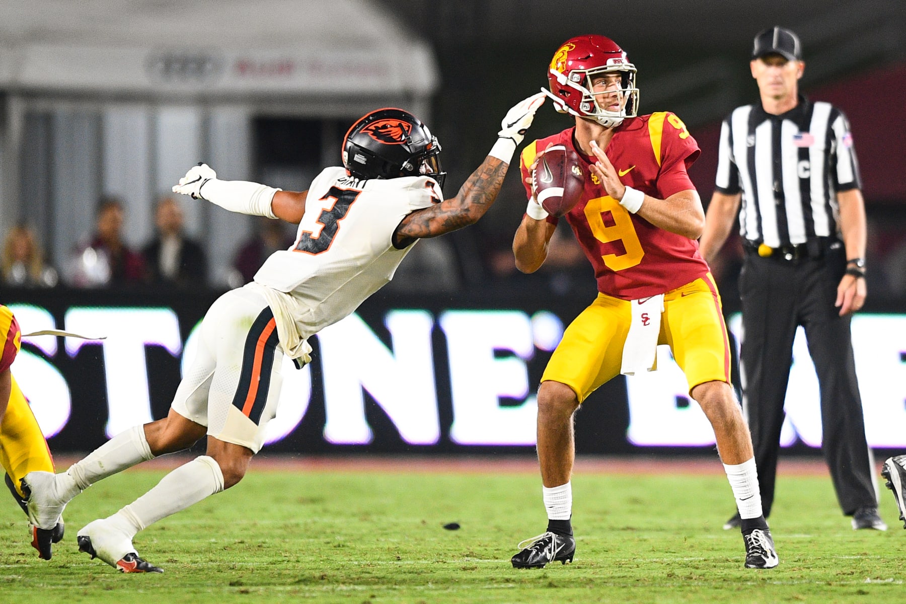 LOS ANGELES, CA - SEPTEMBER 25: USC Trojans quarterback Kedon Slovis (9) is pressured by Oregon State Beavers defensive back Jaydon Grant (3) during a college football game between the Oregon State Beavers and the USC Trojans on September 25, 2021, at Los Angeles Memorial Coliseum in Los Angeles, CA. (Photo by Brian Rothmuller/Icon Sportswire via Getty Images)