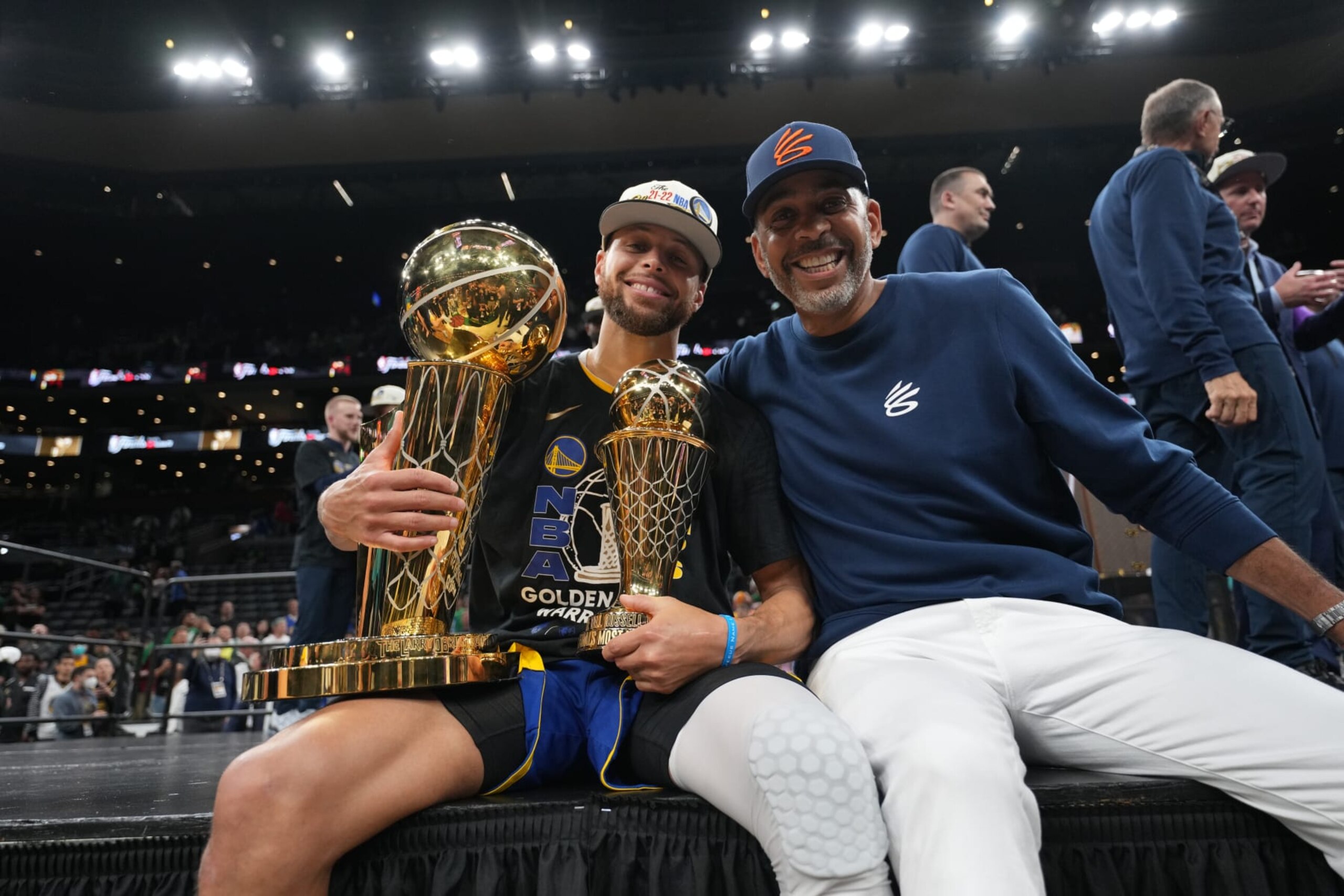 BOSTON, MA - JUNE 16: Stephen Curry #30 of the Golden State Warriors celebrates on stage with The Larry O'Brien Trophy and the Bill Russell Finals MVP Trophy after winning during Game Six of the 2022 NBA Finals on June 16, 2022 at TD Garden in Boston, Massachusetts. NOTE TO USER: User expressly acknowledges and agrees that, by downloading and or using this photograph, user is consenting to the terms and conditions of Getty Images License Agreement. Mandatory Copyright Notice: Copyright 2022 NBAE (Photo by Jesse D. Garrabrant/NBAE via Getty Images)