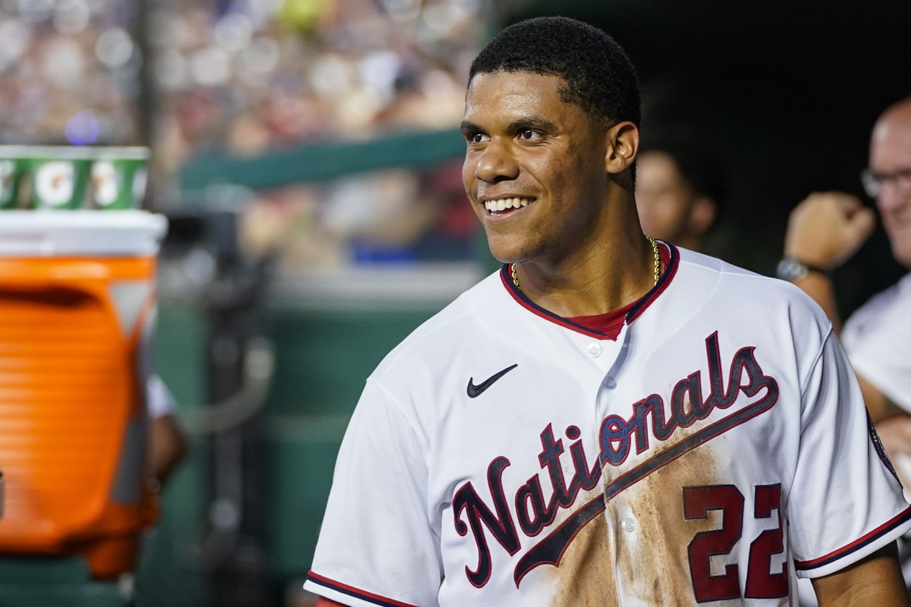 Washington Nationals' Juan Soto smiles in the dugout after a solo home run during a baseball game against the New York Mets at Nationals Park, Monday, Aug. 1, 2022, in Washington. (AP Photo/Alex Brandon)