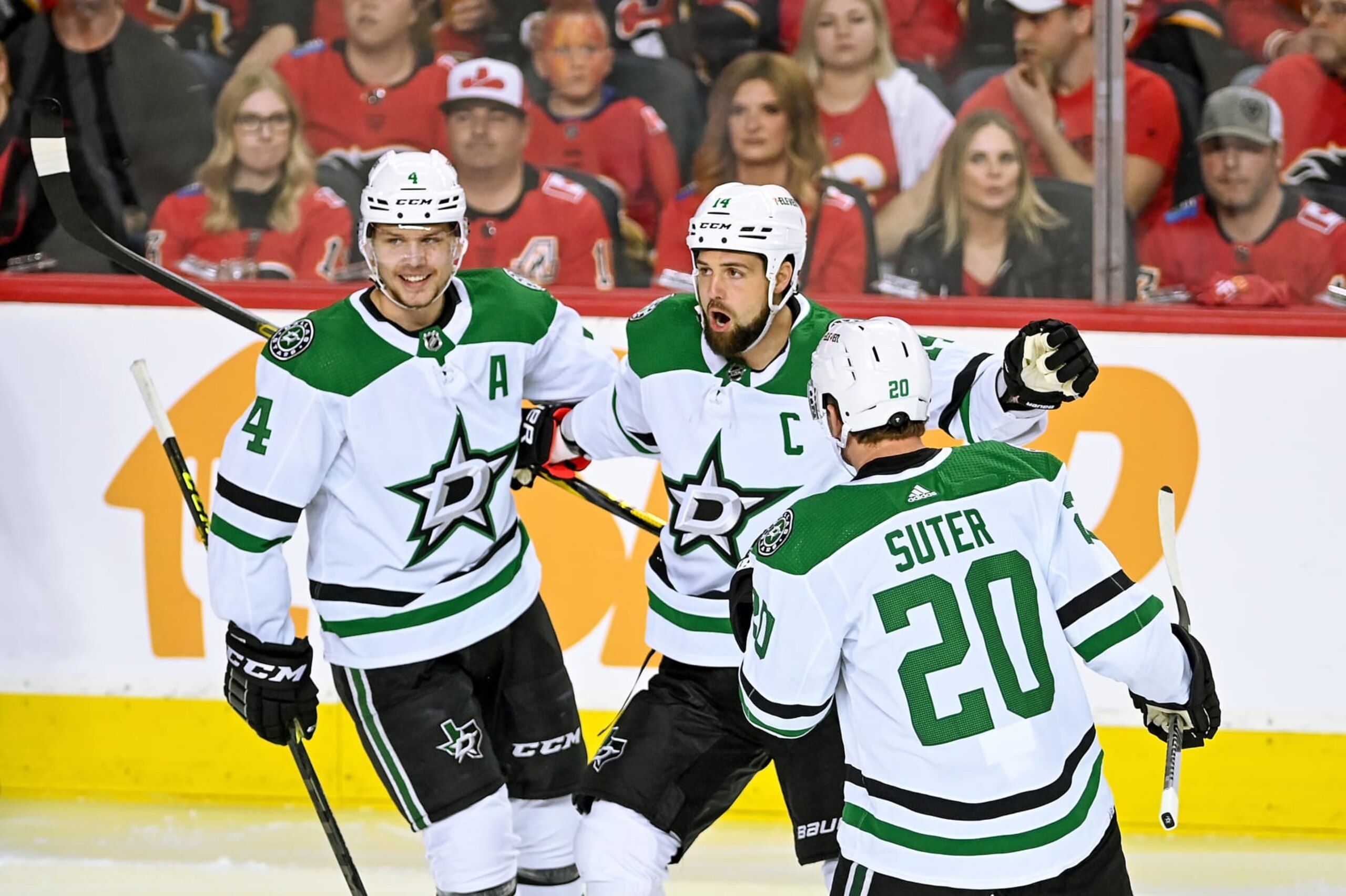 CALGARY, AB - MAY 15: Dallas Stars Left Wing Jamie Benn (14) celebrates with Dallas Stars Defenceman Miro Heiskanen (4) and Dallas Stars Defenceman Ryan Suter (20) after scoring a goal during the first period of game 7 of the first round of the NHL Stanley Cup Playoffs between the Calgary Flames and the Dallas Stars on May 15, 2022, at the Scotiabank Saddledome in Calgary, AB. (Photo by Brett Holmes/Icon Sportswire via Getty Images) CALGARY, AB - MAY 15: Dallas Stars Left Wing Jamie Benn (14) celebrates with Dallas Stars Defenceman Miro Heiskanen (4) and Dallas Stars Defenceman Ryan Suter (20) after scoring a goal during the first period of game 7 of the first round of the NHL Stanley Cup Playoffs between the Calgary Flames and the Dallas Stars on May 15, 2022, at the Scotiabank Saddledome in Calgary, AB. (Photo by Brett Holmes/Icon Sportswire via Getty Images)