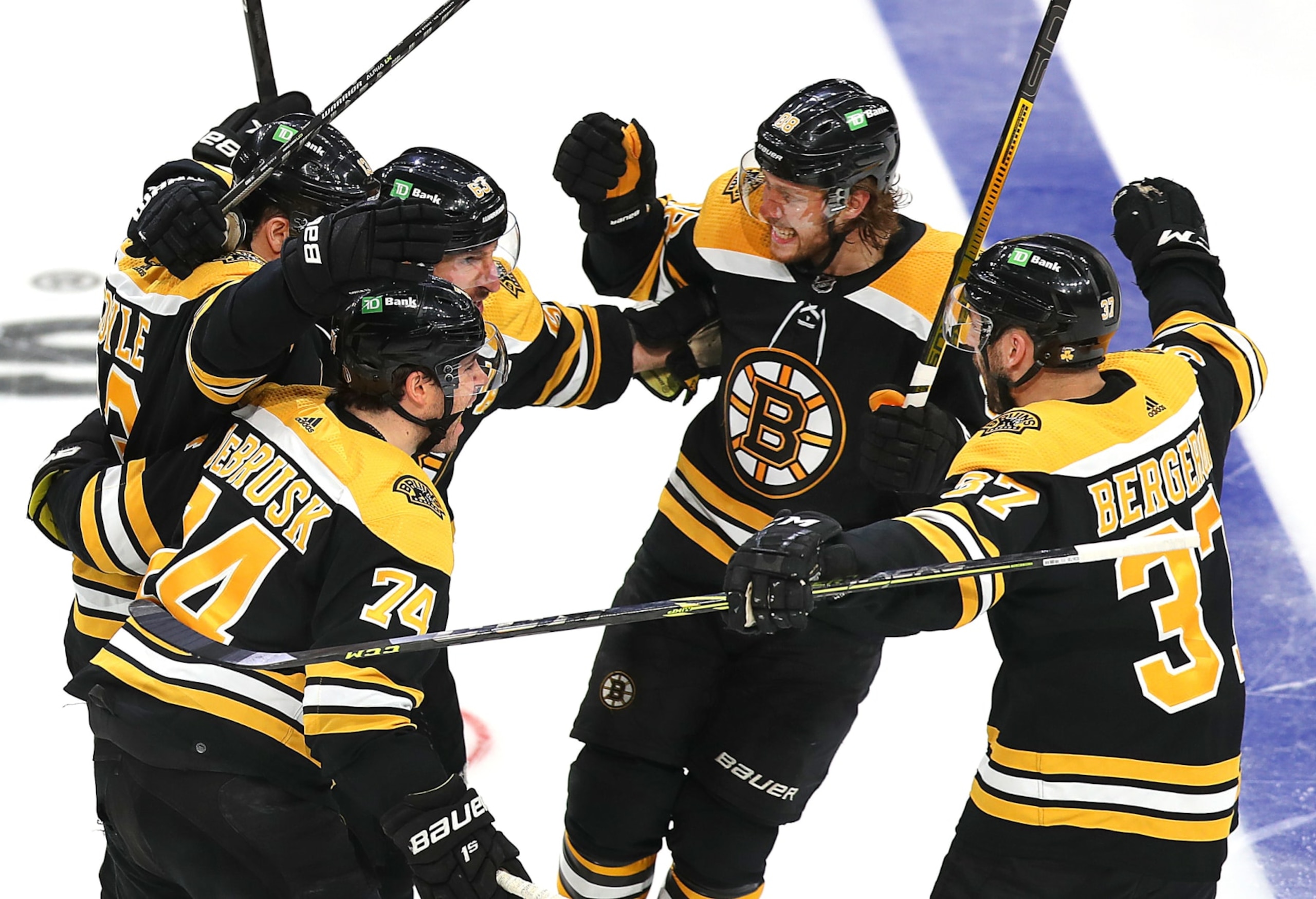 Boston - May 8: The Bruins, Boston Bruins left wing Jake DeBrusk (74), Boston Bruins center Charlie Coyle (13),Boston Bruins left wing Brad Marchand (63), Boston Bruins right wing David Pastrnak (88), and Boston Bruins center Patrice Bergeron (37) celebrate Boston Bruins left wing Brad Marchand (63) (center rear) goal in the 3rd period to put the Bruins ahead, 3-2. The Boston Bruins host the Carolina Hurricanes in an NHL game at TD Garden in Boston on May 8, 2022. (Photo by John Tlumacki/The Boston Globe via Getty Images) Boston - May 8: The Bruins, Boston Bruins left wing Jake DeBrusk (74), Boston Bruins center Charlie Coyle (13),Boston Bruins left wing Brad Marchand (63), Boston Bruins right wing David Pastrnak (88), and Boston Bruins center Patrice Bergeron (37) celebrate Boston Bruins left wing Brad Marchand (63) (center rear) goal in the 3rd period to put the Bruins ahead, 3-2. The Boston Bruins host the Carolina Hurricanes in an NHL game at TD Garden in Boston on May 8, 2022. (Photo by John Tlumacki/The Boston Globe via Getty Images)