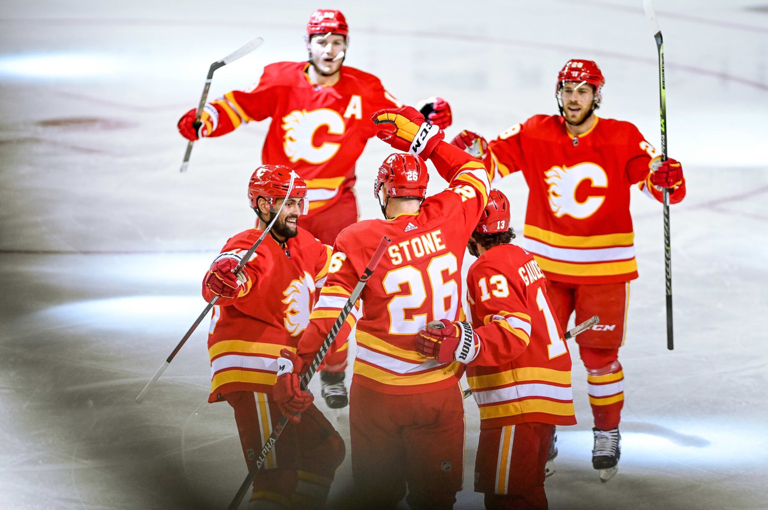 CALGARY, AB - MAY 20: Calgary Flames Defenceman Michael Stone (26) celebrates a goal with Calgary Flames Left Wing Johnny Gaudreau (13), Calgary Flames Defenceman Oliver Kylington (58), Calgary Flames Right Wing Matthew Tkachuk (19) and Calgary Flames Center Elias Lindholm (28) during the first period of game 2 of the second round of the NHL Stanley Cup Playoffs between the Calgary Flames and the Edmonton Oilers on May 20, 2022, at the Scotiabank Saddledome in Calgary, AB. (Photo by Brett Holmes/Icon Sportswire via Getty Images) CALGARY, AB - MAY 20: Calgary Flames Defenceman Michael Stone (26) celebrates a goal with Calgary Flames Left Wing Johnny Gaudreau (13), Calgary Flames Defenceman Oliver Kylington (58), Calgary Flames Right Wing Matthew Tkachuk (19) and Calgary Flames Center Elias Lindholm (28) during the first period of game 2 of the second round of the NHL Stanley Cup Playoffs between the Calgary Flames and the Edmonton Oilers on May 20, 2022, at the Scotiabank Saddledome in Calgary, AB. (Photo by Brett Holmes/Icon Sportswire via Getty Images)