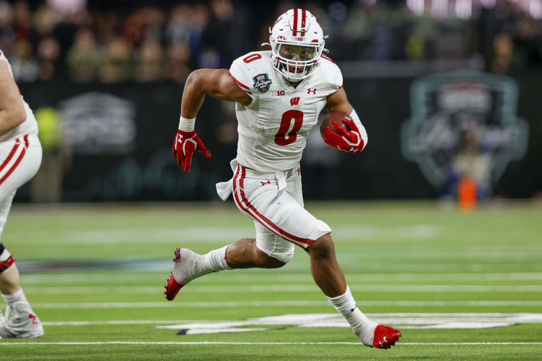 LAS VEGAS, NV - DECEMBER 30: Wisconsin Badgers running back Braelon Allen (0) runs the ball for a gain during the SRS Distribution Las Vegas Bowl between the Wisconsin Badgers and the Arizona State Sun Devils on December 30, 2021 at Allegiant Stadium in Las Vegas, NV. (Photo by Jordon Kelly/Icon Sportswire via Getty Images) LAS VEGAS, NV - DECEMBER 30: Wisconsin Badgers running back Braelon Allen (0) runs the ball for a gain during the SRS Distribution Las Vegas Bowl between the Wisconsin Badgers and the Arizona State Sun Devils on December 30, 2021 at Allegiant Stadium in Las Vegas, NV. (Photo by Jordon Kelly/Icon Sportswire via Getty Images)