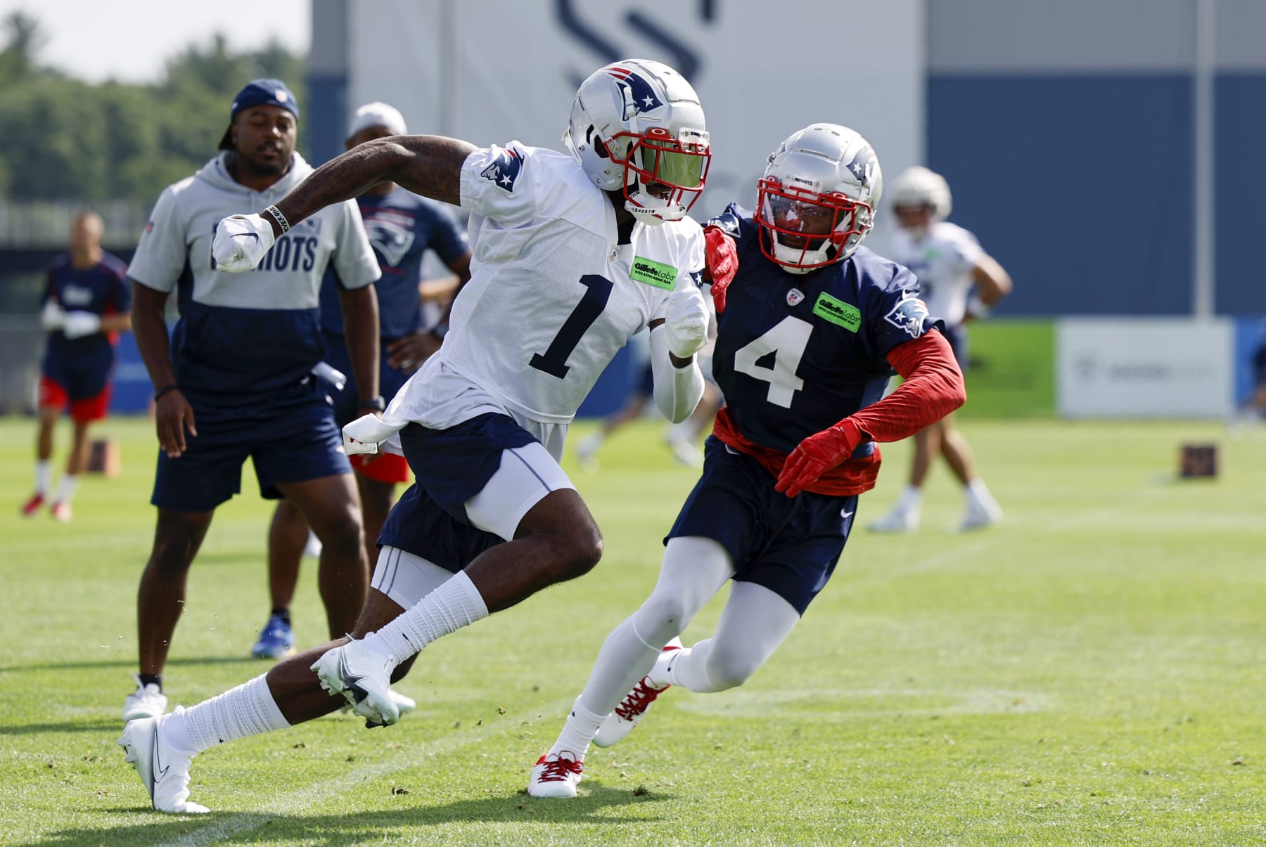 FOXBOROUGH, MA - JULY 29: New England Patriots wide receiver DeVante Parker (1) gets past New England Patriots cornerback Malcom Butler (4) during New England Patriots training camp on July 29, 2022, at the Patriots Training Facility at Gillette Stadium in Foxborough, Massachusetts. (Photo by Fred Kfoury III/Icon Sportswire via Getty Images)