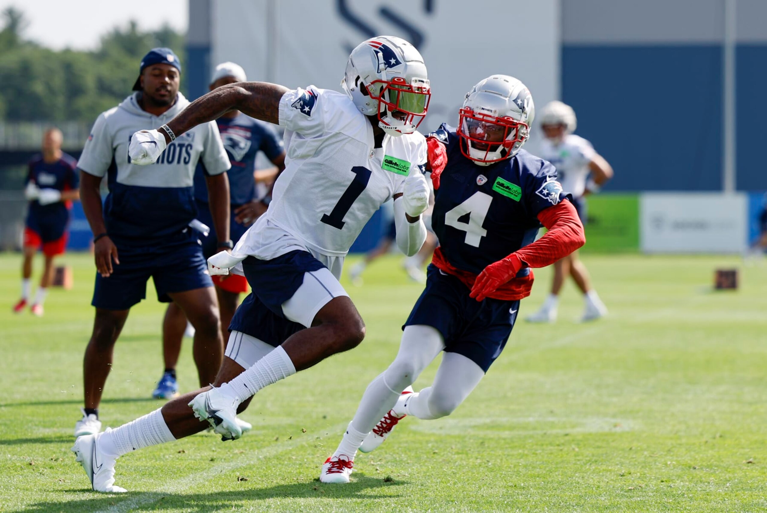FOXBOROUGH, MA - JULY 29: New England Patriots wide receiver DeVante Parker (1) gets past New England Patriots cornerback Malcom Butler (4) during New England Patriots training camp on July 29, 2022, at the Patriots Training Facility at Gillette Stadium in Foxborough, Massachusetts. (Photo by Fred Kfoury III/Icon Sportswire via Getty Images)