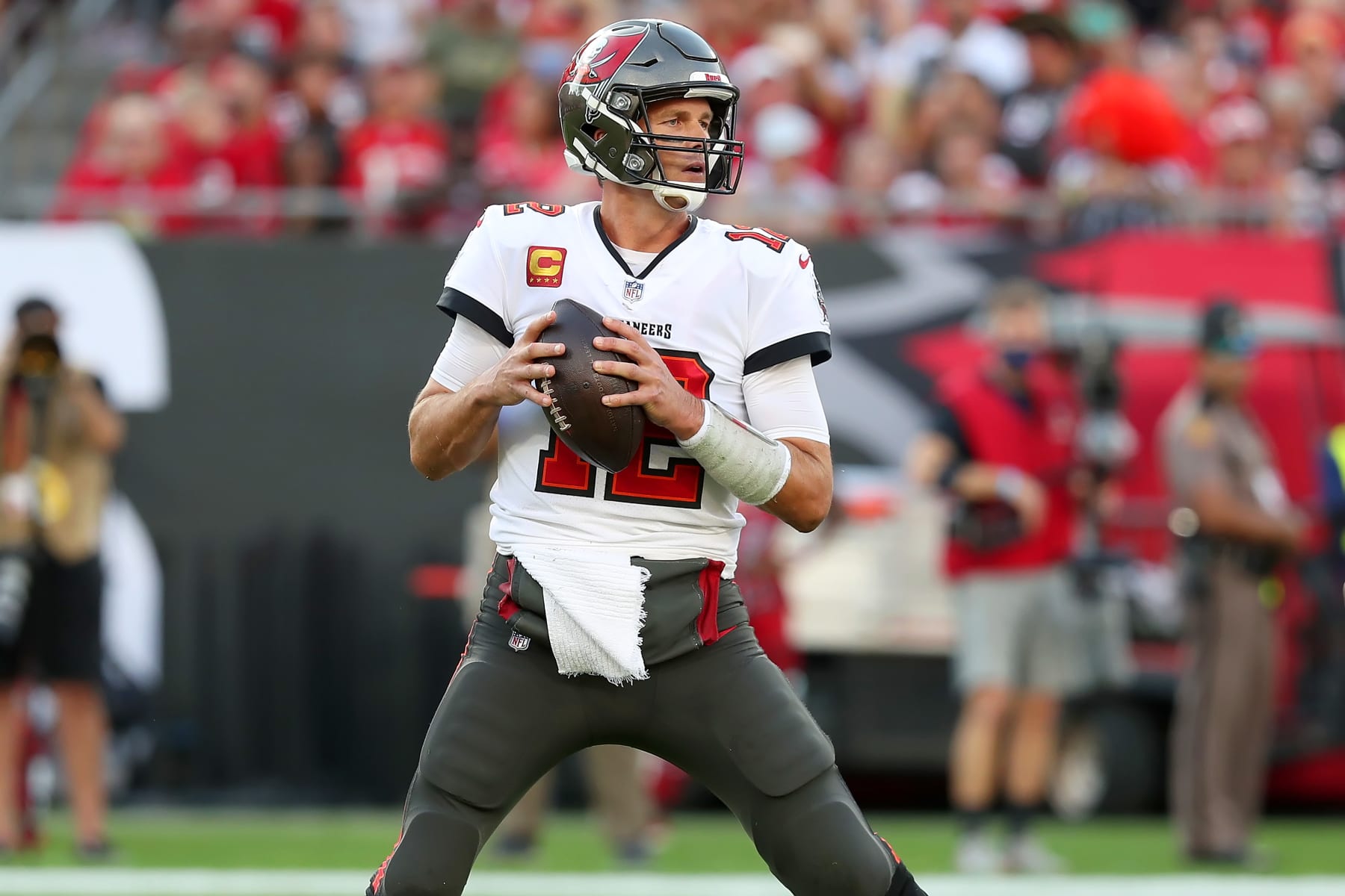 TAMPA, FL - JANUARY 9: Tampa Bay Buccaneers Quarterback Tom Brady (12) looks for an open receiver during the regular season game between the Carolina Panthers and the Tampa Bay Buccaneers on January 9, 2022 at Raymond James Stadium in Tampa, Florida. (Photo by Cliff Welch/Icon Sportswire via Getty Images)