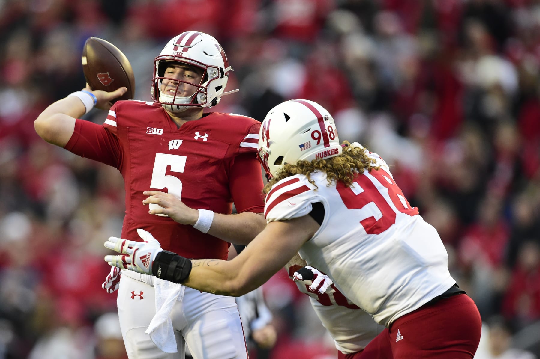 MADISON, WISCONSIN - NOVEMBER 20: Graham Mertz #5 of the Wisconsin Badgers looks to pass the ball against Casey Rogers #98 of the Nebraska Cornhuskers in the first half at Camp Randall Stadium on November 20, 2021 in Madison, Wisconsin. (Photo by Patrick McDermott/Getty Images)