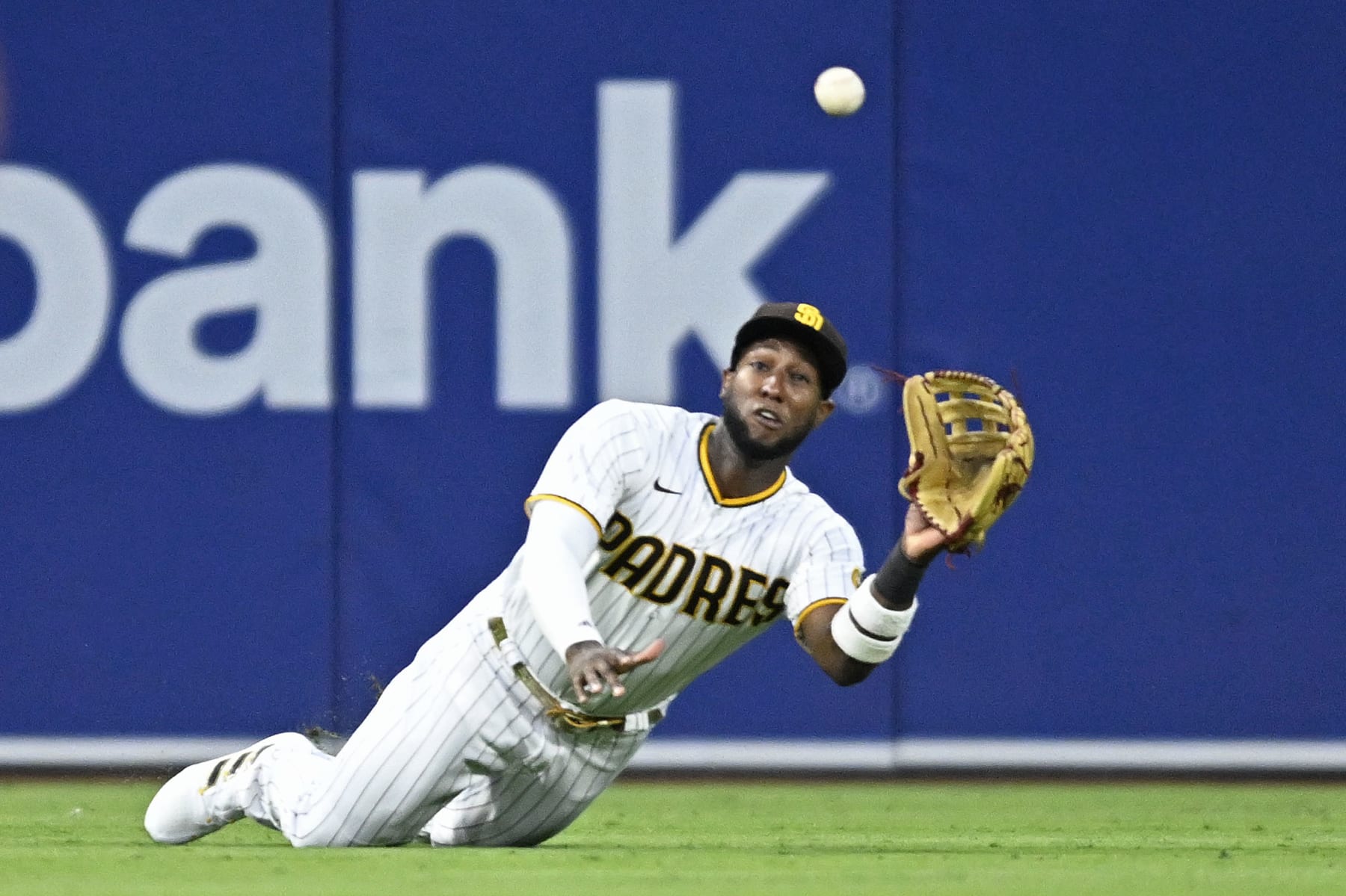 SAN DIEGO, CA - AUGUST 1:   Jurickson Profar #10 of the San Diego Padres makes a diving catch on a ball off the bat of Randal Grichuk of the Colorado Rockies during the fourth inning August 1, 2022 at Petco Park in San Diego, California. (Photo by Denis Poroy/Getty Images)