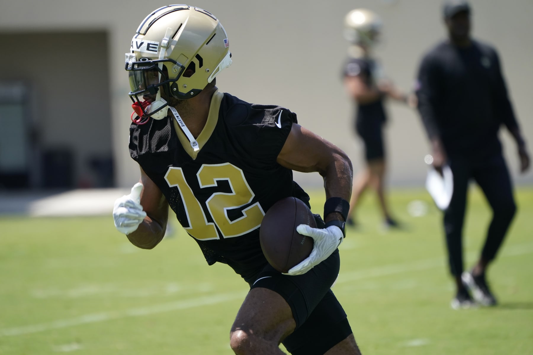 New Orleans Saints wide receiver Chris Olave (12) runs through drills during an NFL football practice in Metairie, La., Thursday, June 2, 2022. (AP Photo/Gerald Herbert)