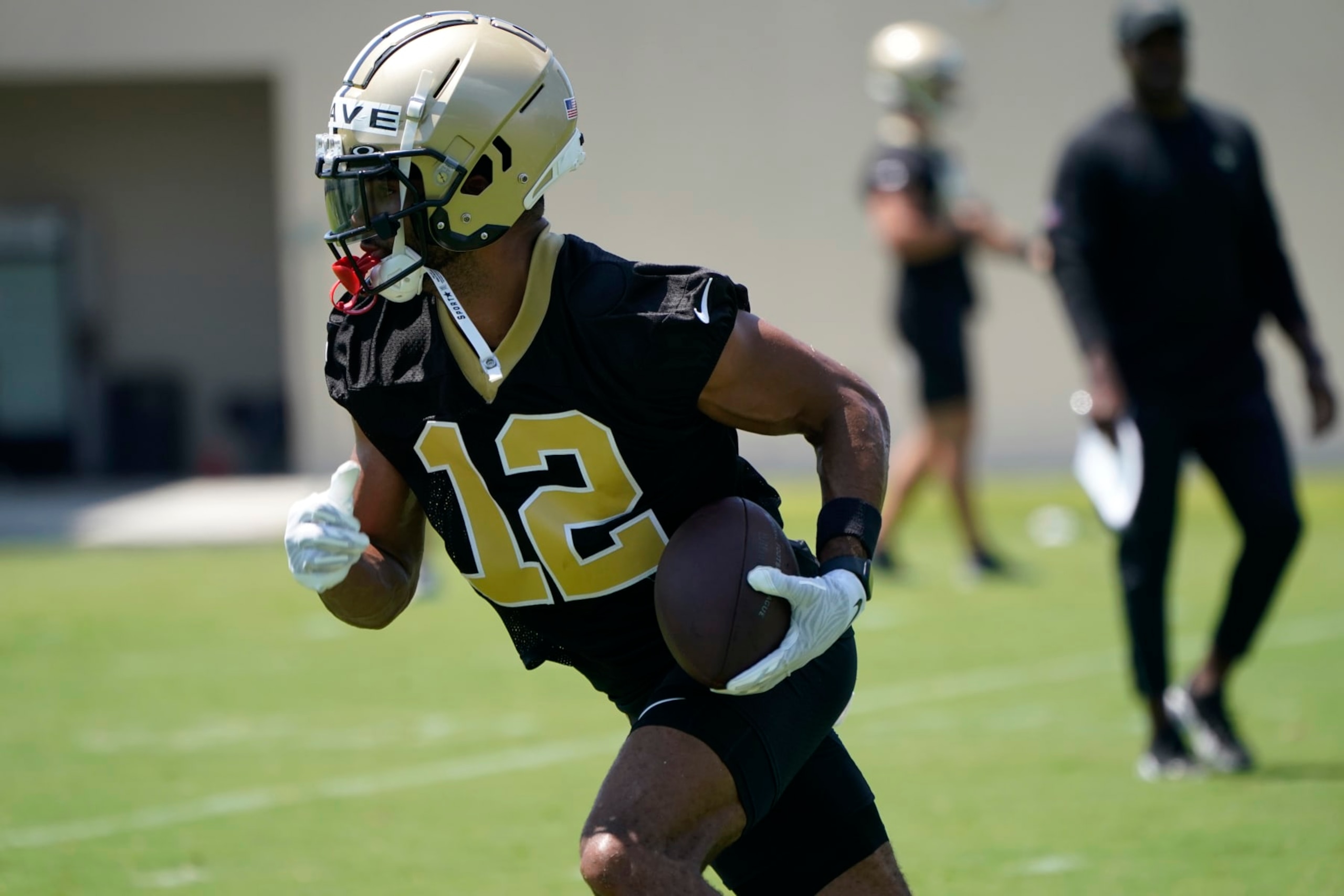 New Orleans Saints wide receiver Chris Olave (12) runs through drills during an NFL football practice in Metairie, La., Thursday, June 2, 2022. (AP Photo/Gerald Herbert)