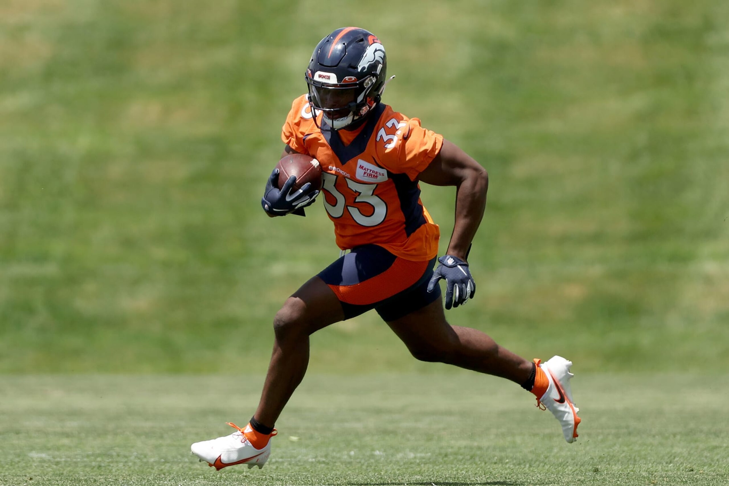 ENGLEWOOD, COLORADO - JUNE 14: Javonte Williams #33 of the Denver Broncos runs with the ball on the field during a mandatory mini-camp at UCHealth Training Center on June 14, 2022 in Englewood, Colorado. (Photo by Matthew Stockman/Getty Images) ENGLEWOOD, COLORADO - JUNE 14: Javonte Williams #33 of the Denver Broncos runs with the ball on the field during a mandatory mini-camp at UCHealth Training Center on June 14, 2022 in Englewood, Colorado. (Photo by Matthew Stockman/Getty Images)