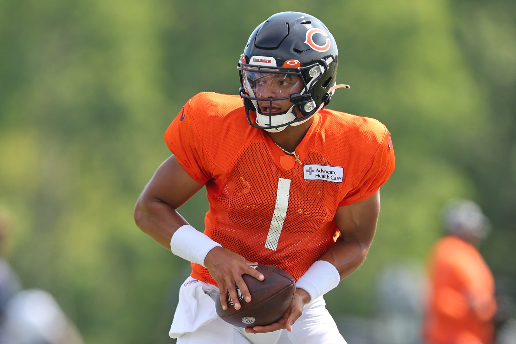 LAKE FOREST, ILLINOIS - AUGUST 02: Justin Fields #1 of the Chicago Bears takes part in a drill during training camp at the PNC Center at Halas Hall on August 02, 2022 in Lake Forest, Illinois. (Photo by Michael Reaves/Getty Images)