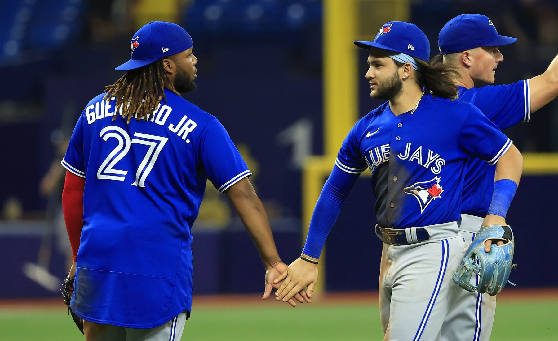 ST PETERSBURG, FLORIDA - AUGUST 02: Vladimir Guerrero Jr. #27 and Bo Bichette #11 of the Toronto Blue Jays celebrate after winning a game against the Tampa Bay Rays at Tropicana Field on August 02, 2022 in St Petersburg, Florida. (Photo by Mike Ehrmann/Getty Images)