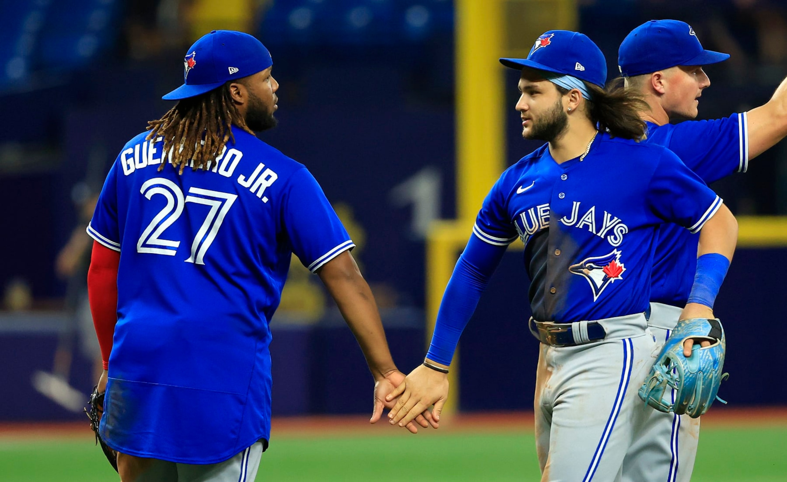 ST PETERSBURG, FLORIDA - AUGUST 02: Vladimir Guerrero Jr. #27 and Bo Bichette #11 of the Toronto Blue Jays celebrate after winning a game against the Tampa Bay Rays at Tropicana Field on August 02, 2022 in St Petersburg, Florida. (Photo by Mike Ehrmann/Getty Images)