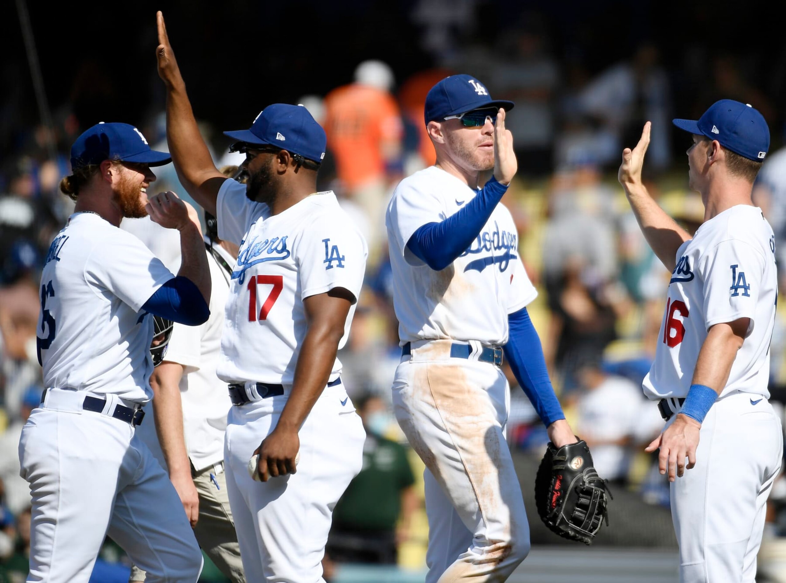 LOS ANGELES, CA - JULY 24:  (L-R) Craig Kimbrel #46, Hanser Alberto #17, Freddie Freeman #5 and Will Smith #16 of the Los Angeles Dodgers celebrate a 7-4 win over the San Francisco Giants at Dodger Stadium on July 24, 2022 in Los Angeles, California. (Photo by Kevork Djansezian/Getty Images)