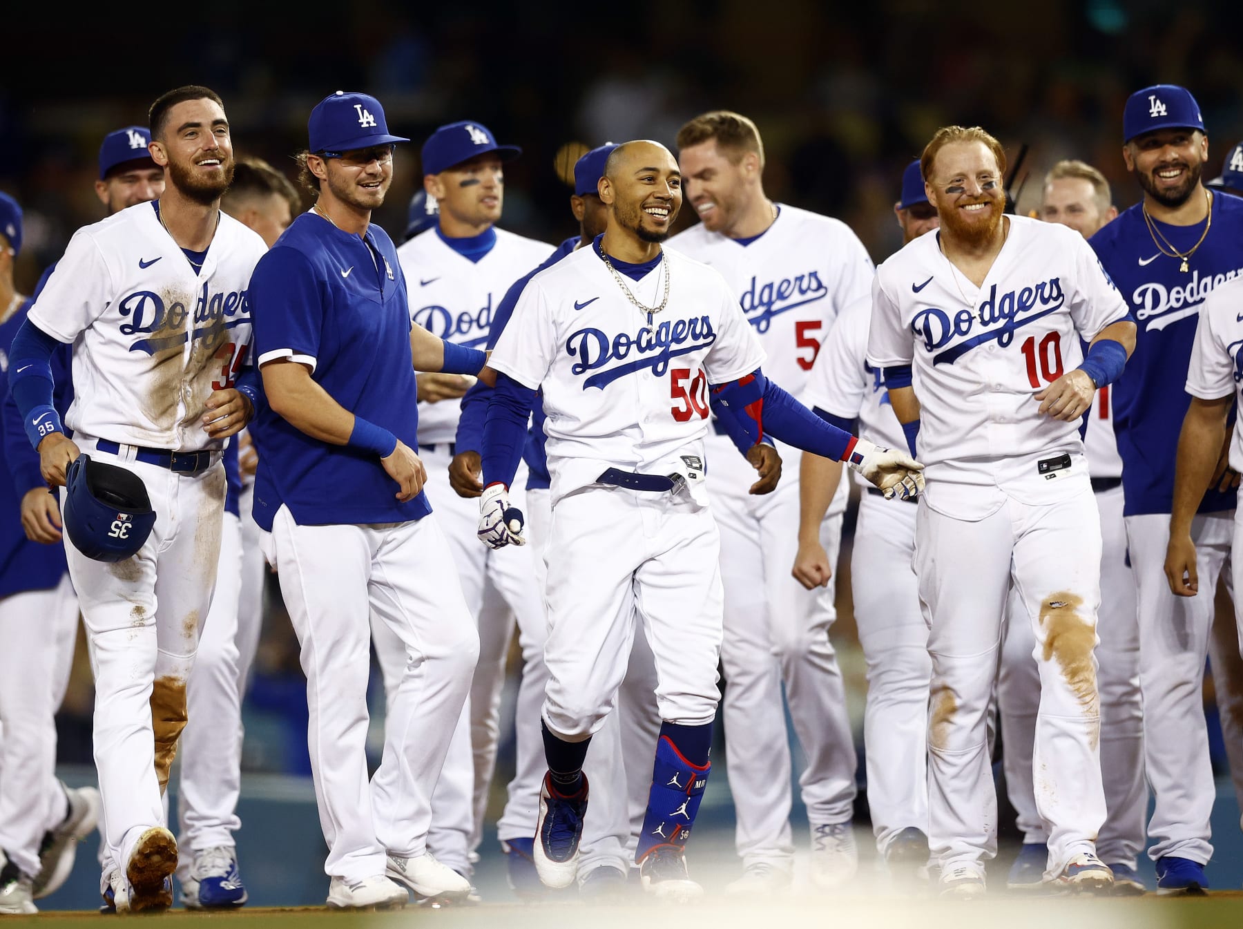 LOS ANGELES, CALIFORNIA - JULY 06:  Mookie Betts #50 of the Los Angeles Dodgers celebrates a walk-off single against the Colorado Rockies at Dodger Stadium on July 06, 2022 in Los Angeles, California. (Photo by Ronald Martinez/Getty Images)
