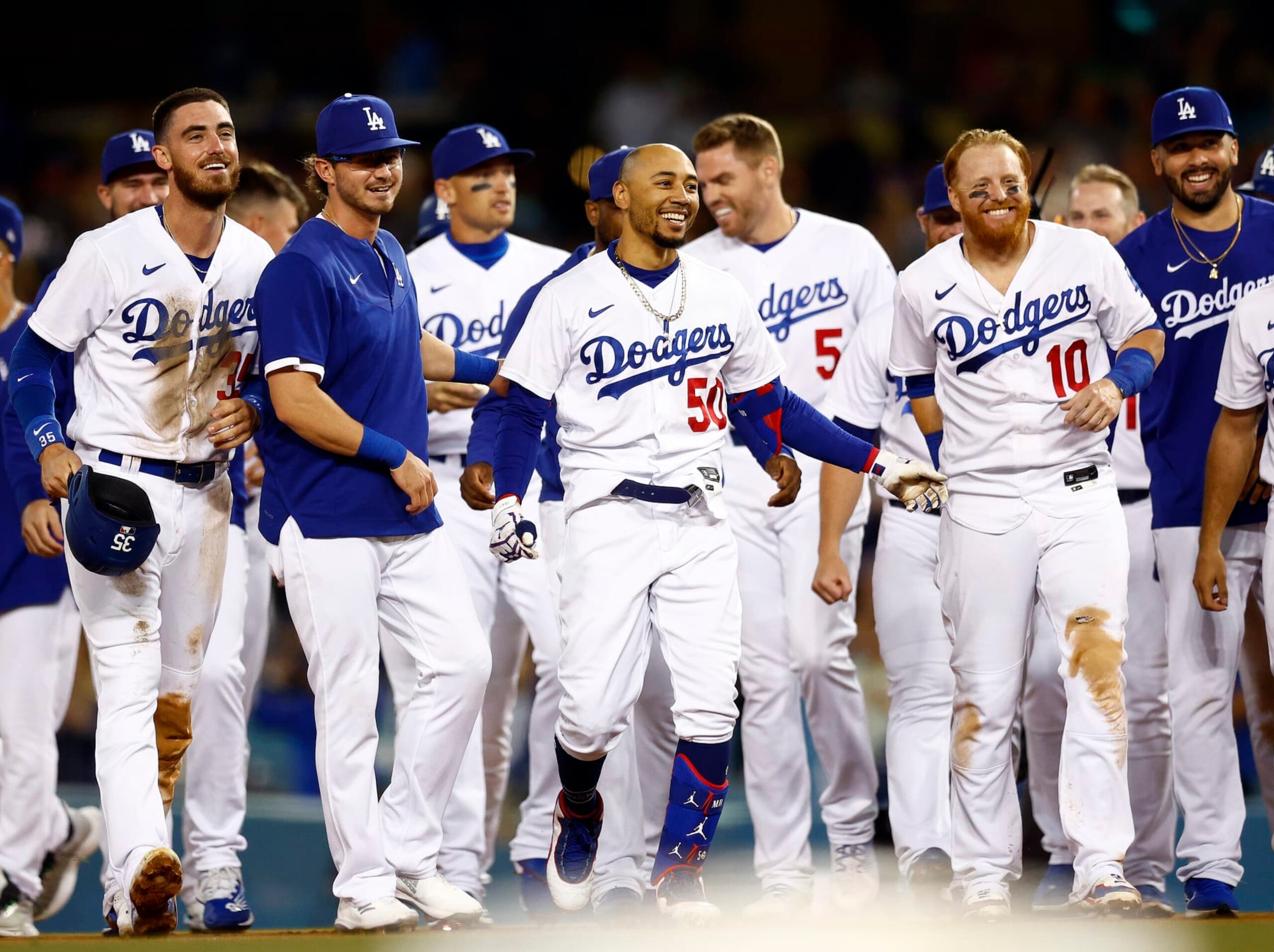 LOS ANGELES, CALIFORNIA - JULY 06:  Mookie Betts #50 of the Los Angeles Dodgers celebrates a walk-off single against the Colorado Rockies at Dodger Stadium on July 06, 2022 in Los Angeles, California. (Photo by Ronald Martinez/Getty Images)