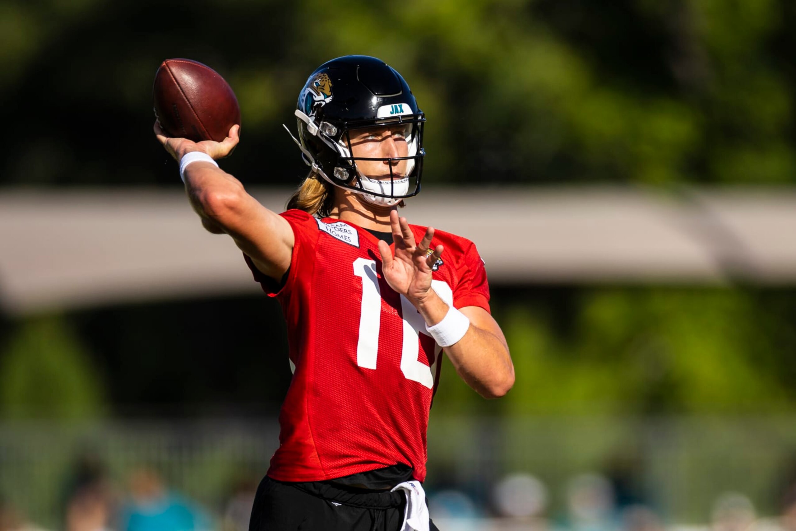 JACKSONVILLE, FLORIDA - JULY 27: Trevor Lawrence #16 of the Jacksonville Jaguars throws a pass during training camp on July 27, 2022 at Episcopal High School in Jacksonville, Florida. (Photo by James Gilbert/Getty Images)