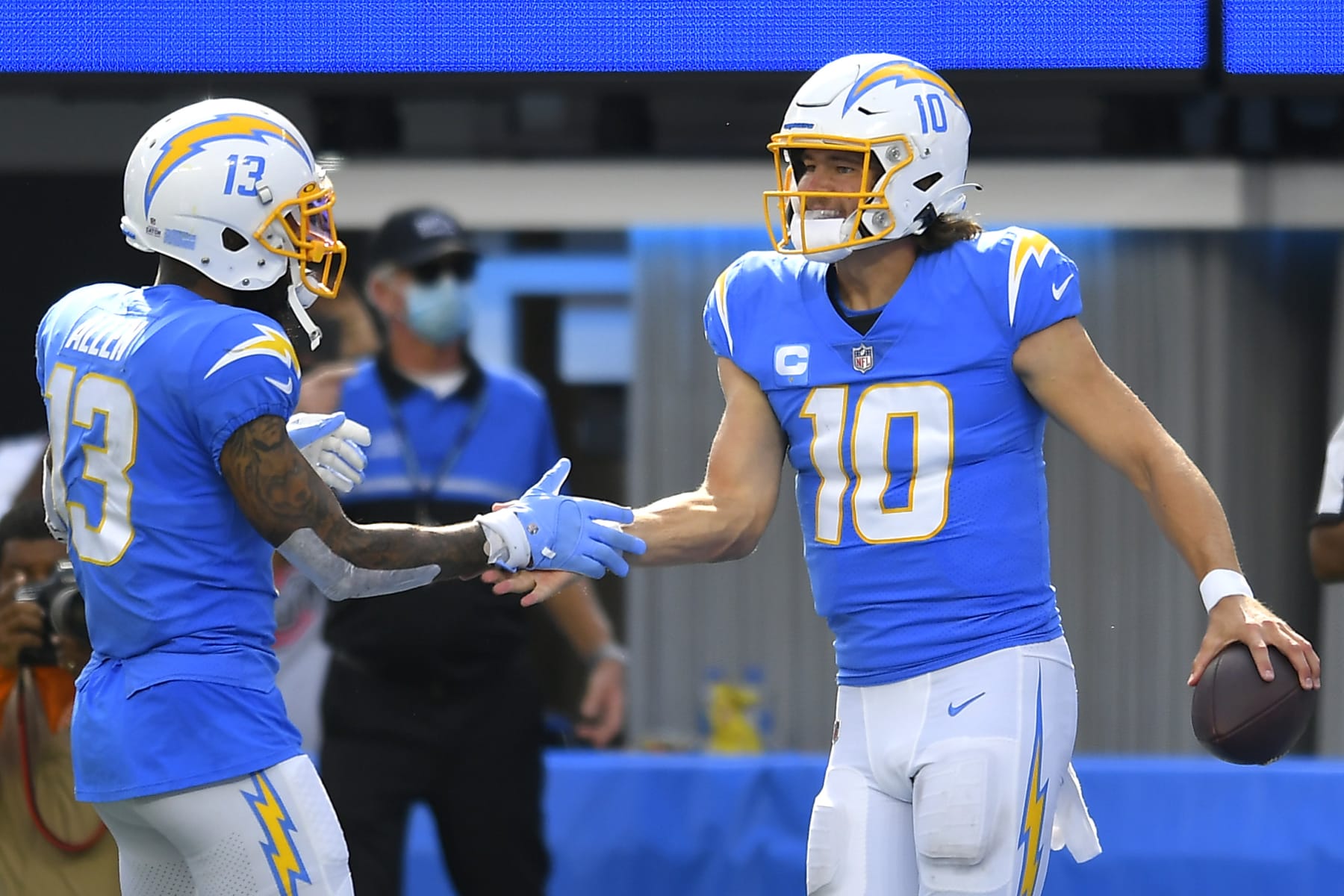 INGLEWOOD, CALIFORNIA - OCTOBER 10: Justin Herbert #10 of the Los Angeles Chargers celebrates with Keenan Allen #13 after running for a touchdown during the second half at SoFi Stadium on October 10, 2021 in Inglewood, California. (Photo by John McCoy/Getty Images)