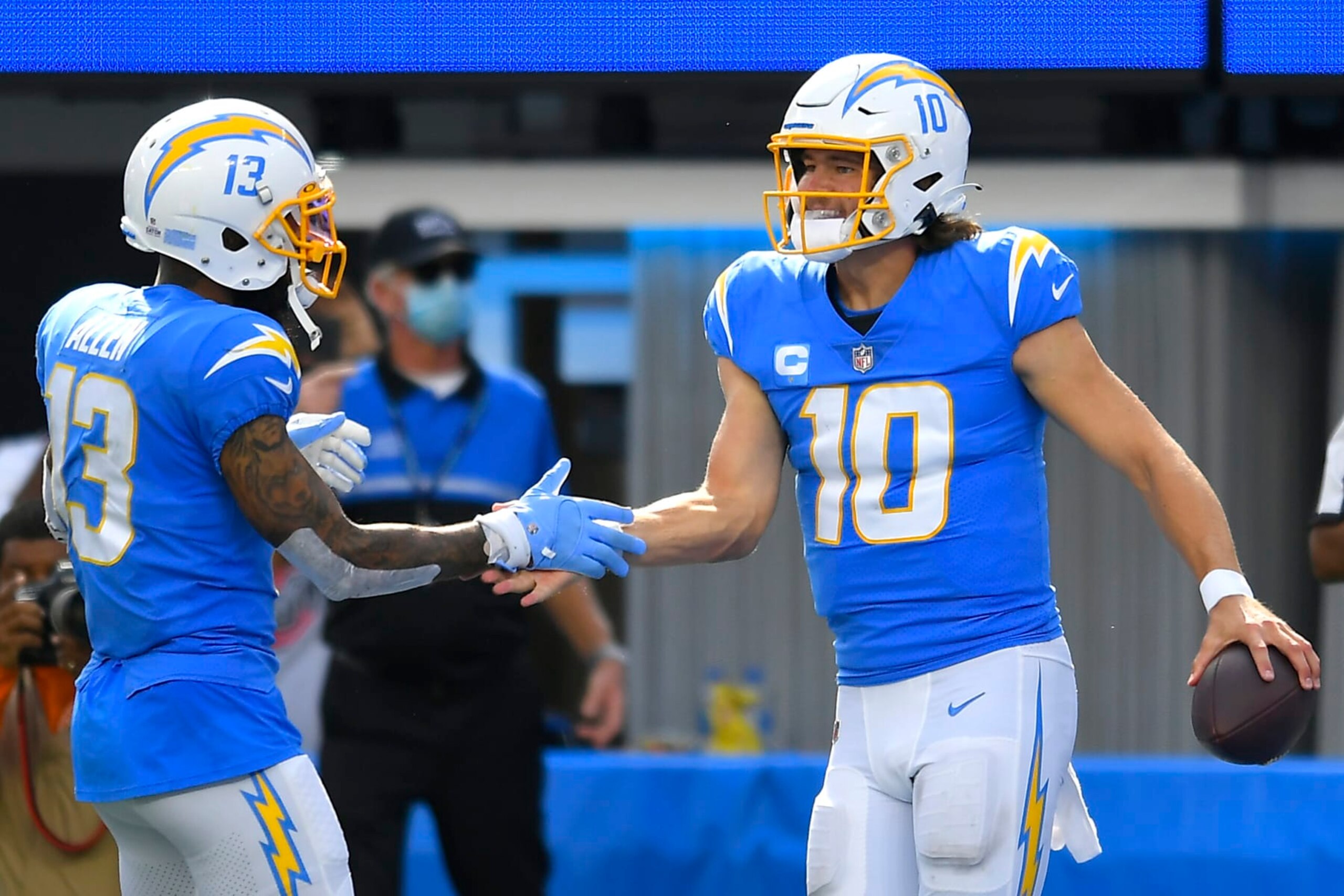 INGLEWOOD, CALIFORNIA - OCTOBER 10: Justin Herbert #10 of the Los Angeles Chargers celebrates with Keenan Allen #13 after running for a touchdown during the second half at SoFi Stadium on October 10, 2021 in Inglewood, California. (Photo by John McCoy/Getty Images)