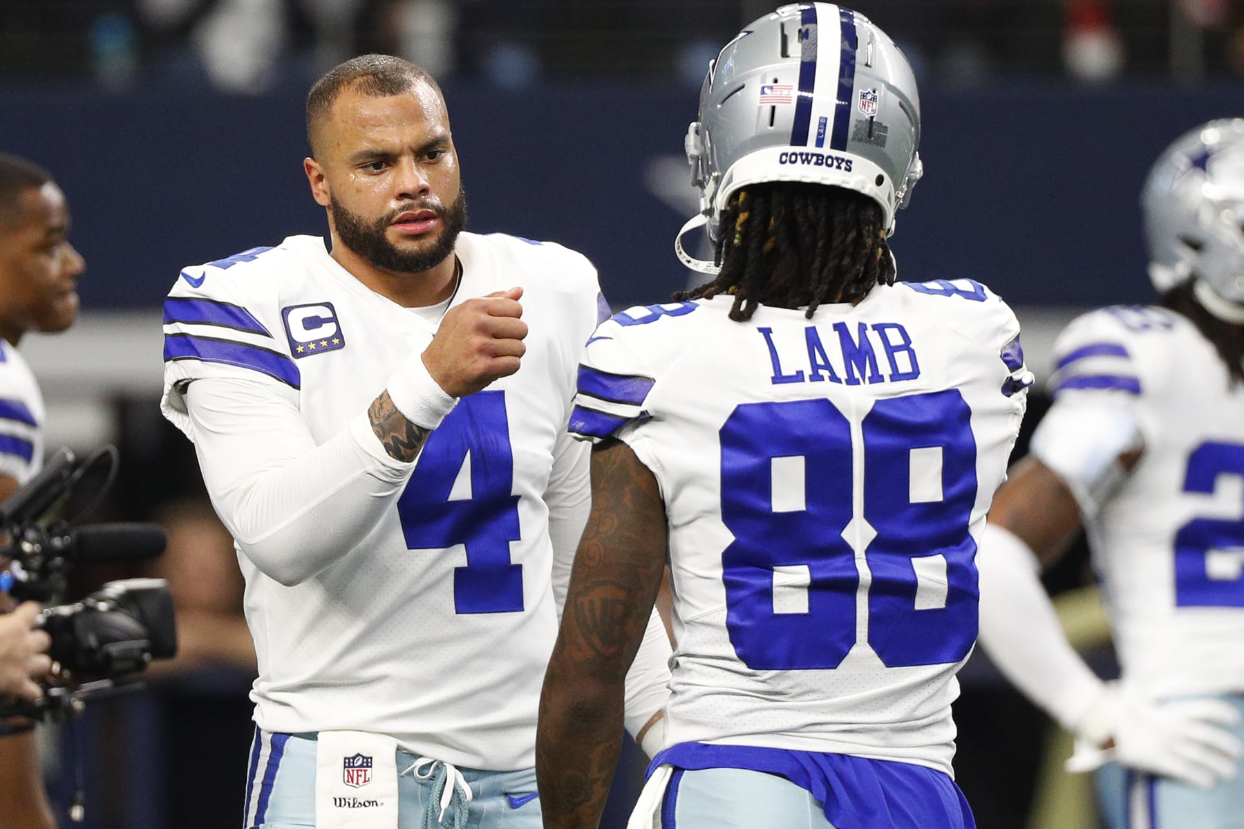 ARLINGTON, TEXAS - JANUARY 16: Dak Prescott #4 and CeeDee Lamb #88 of the Dallas Cowboys warm up prior to a game against the San Francisco 49ers in the NFC Wild Card Playoff game at AT&T Stadium on January 16, 2022 in Arlington, Texas. (Photo by Richard Rodriguez/Getty Images)