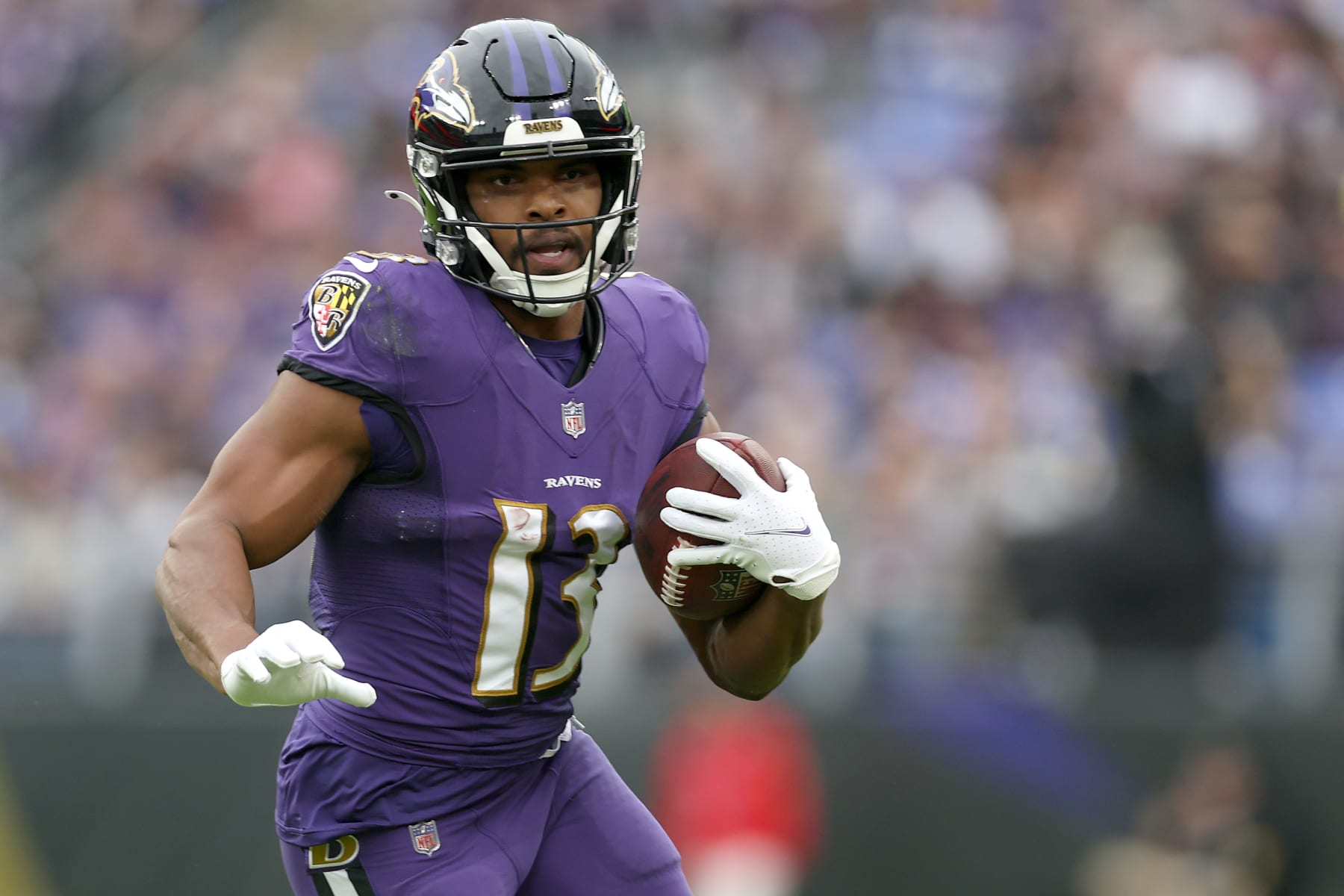 BALTIMORE, MARYLAND - JANUARY 02:  Devin Duvernay #13 of the Baltimore Ravens runs with the ball after catching a pass against the Los Angeles Rams at M&T Bank Stadium on January 02, 2022 in Baltimore, Maryland. (Photo by Rob Carr/Getty Images)