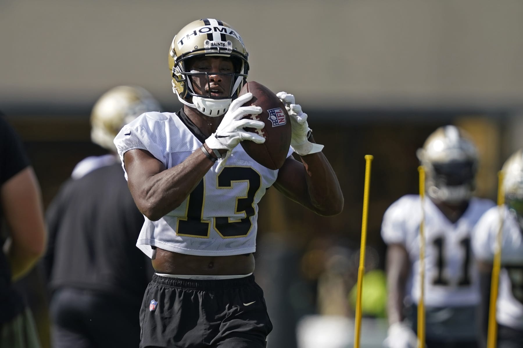 New Orleans Saints wide receiver Michael Thomas (13) runs through drills during training camp at their NFL football training facility in Metairie, La., Friday, July 29, 2022. (AP Photo/Gerald Herbert)
