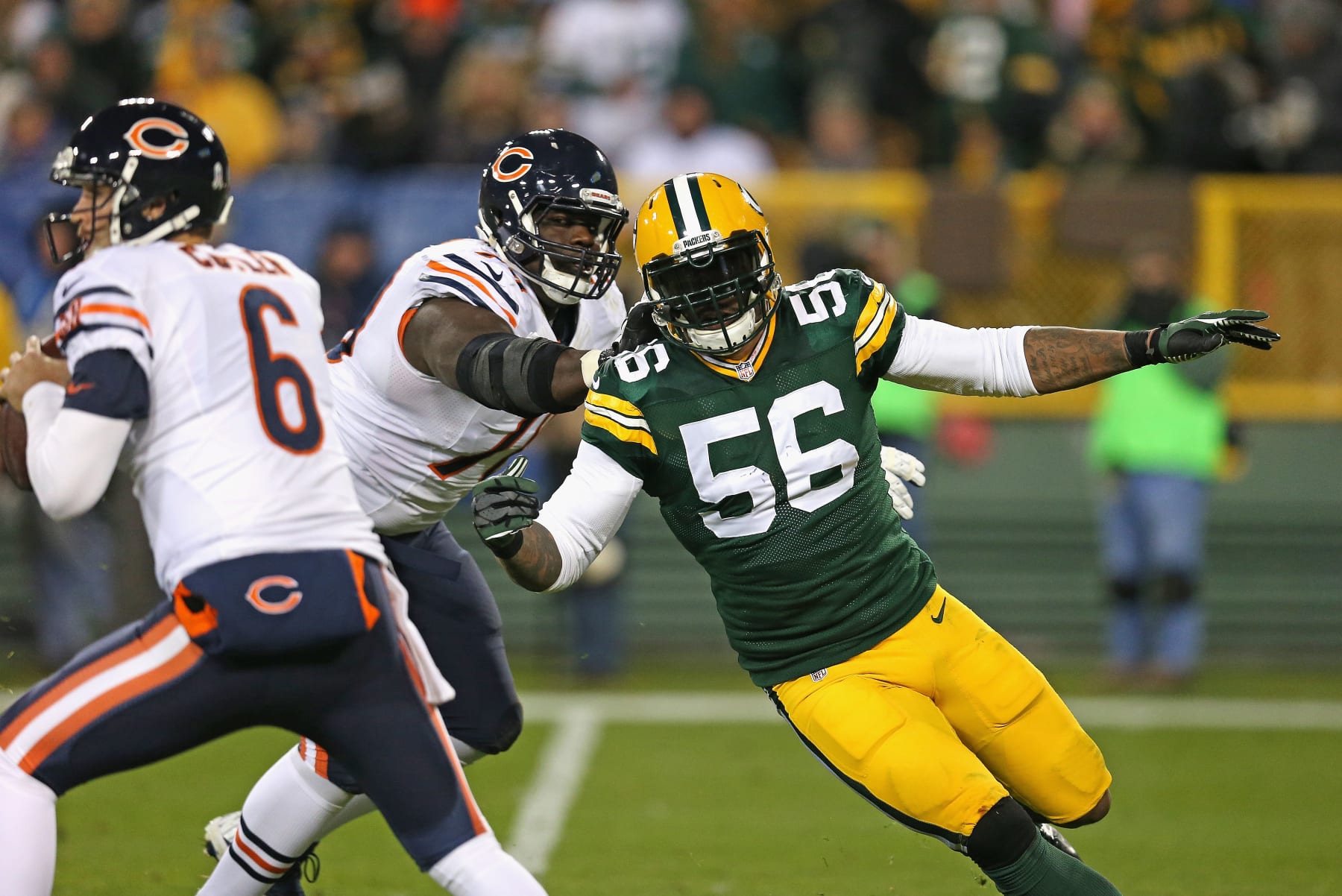 GREEN BAY, WI - NOVEMBER 09:  Julius Peppers #56 of the Green Bay Packers rushes past  Jermon Bushrod #74 of the Chicago Bears towards quarterback Jay Cutler #6 at Lambeau Field on November 9, 2014 in Green Bay, Wisconsin. (Photo by Jonathan Daniel/Getty Images)
