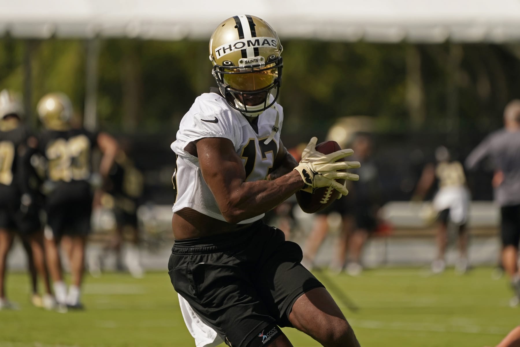 New Orleans Saints wide receiver Michael Thomas (13) runs though drills during training camp at their NFL football training facility in Metairie, La., Wednesday, July 27, 2022. (AP Photo/Gerald Herbert)