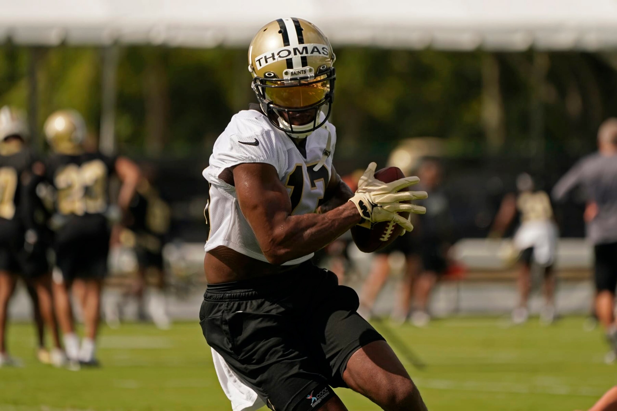 New Orleans Saints wide receiver Michael Thomas (13) runs though drills during training camp at their NFL football training facility in Metairie, La., Wednesday, July 27, 2022. (AP Photo/Gerald Herbert)