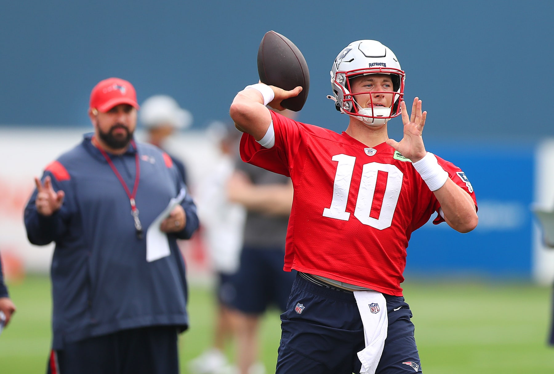 Foxborough, MA - July 28: Matt Patricia keeps an eye on QB Mac Jones firing a pass as the New England Patriots held their 2nd day of training camp on the practice fields behind Gillette Stadium. (Photo by John Tlumacki/The Boston Globe via Getty Images)