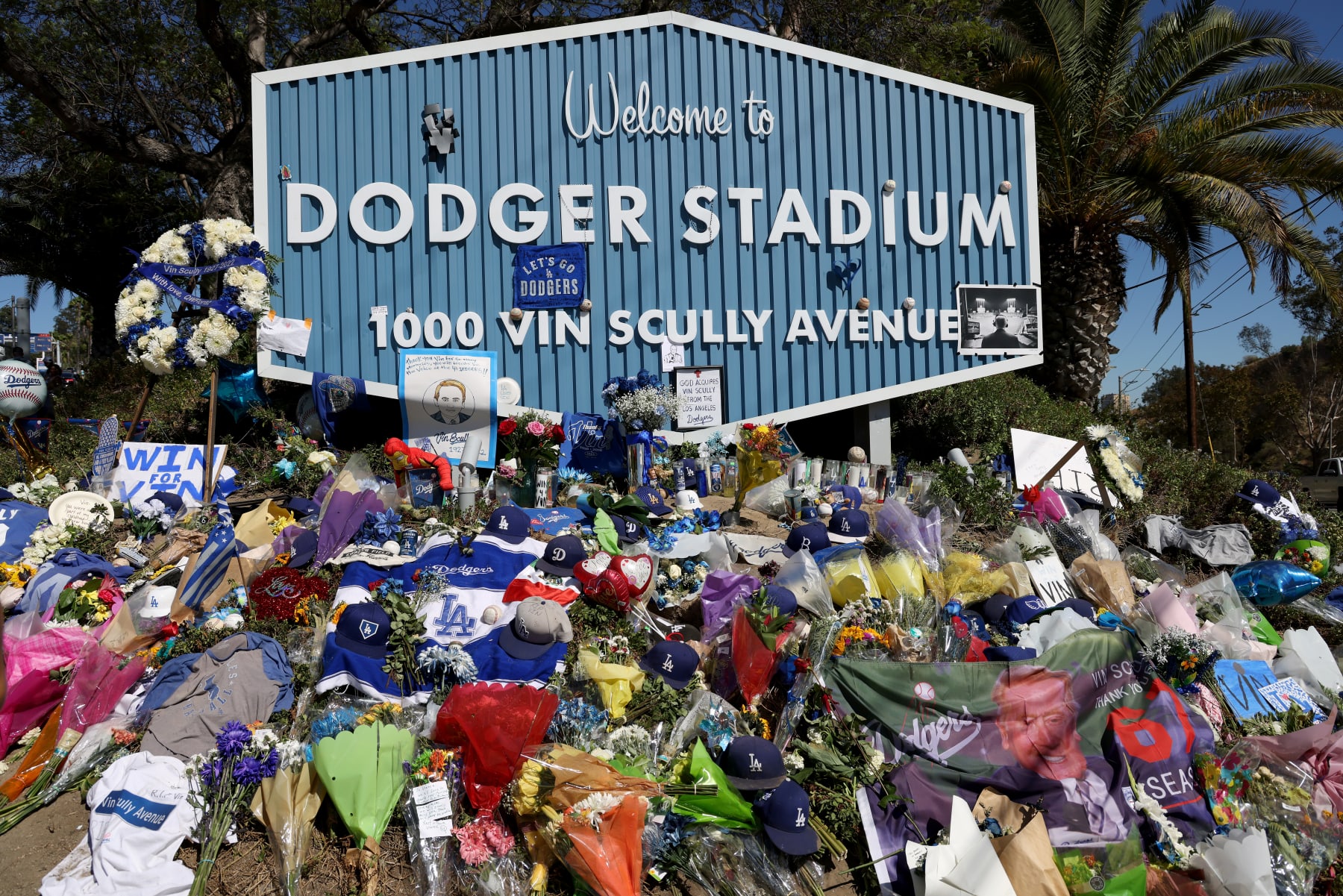 LOS ANGELES, CALIFORNIA - AUGUST 05: Flowers and gestures left at the Sunset entrance in a tribute to Los Angeles Dodgers broadcaster Vin Scully who died on August 2, 2022 at Dodger Stadium on August 05, 2022 in Los Angeles, California. (Photo by Harry How/Getty Images)