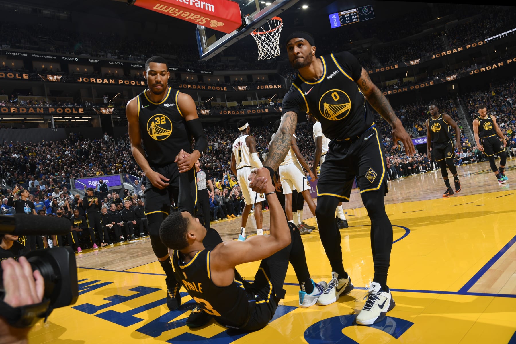 SAN FRANCISCO, CA - APRIL 27: Otto Porter Jr. #32 of the Golden State Warriors and Gary Payton II #0 help up Jordan Poole #3 during Round 1 Game 5 of the 2022 NBA Playoffs on April 27, 2022 at Chase Center in San Francisco, California. NOTE TO USER: User expressly acknowledges and agrees that, by downloading and or using this photograph, user is consenting to the terms and conditions of Getty Images License Agreement. Mandatory Copyright Notice: Copyright 2022 NBAE (Photo by Noah Graham/NBAE via Getty Images)