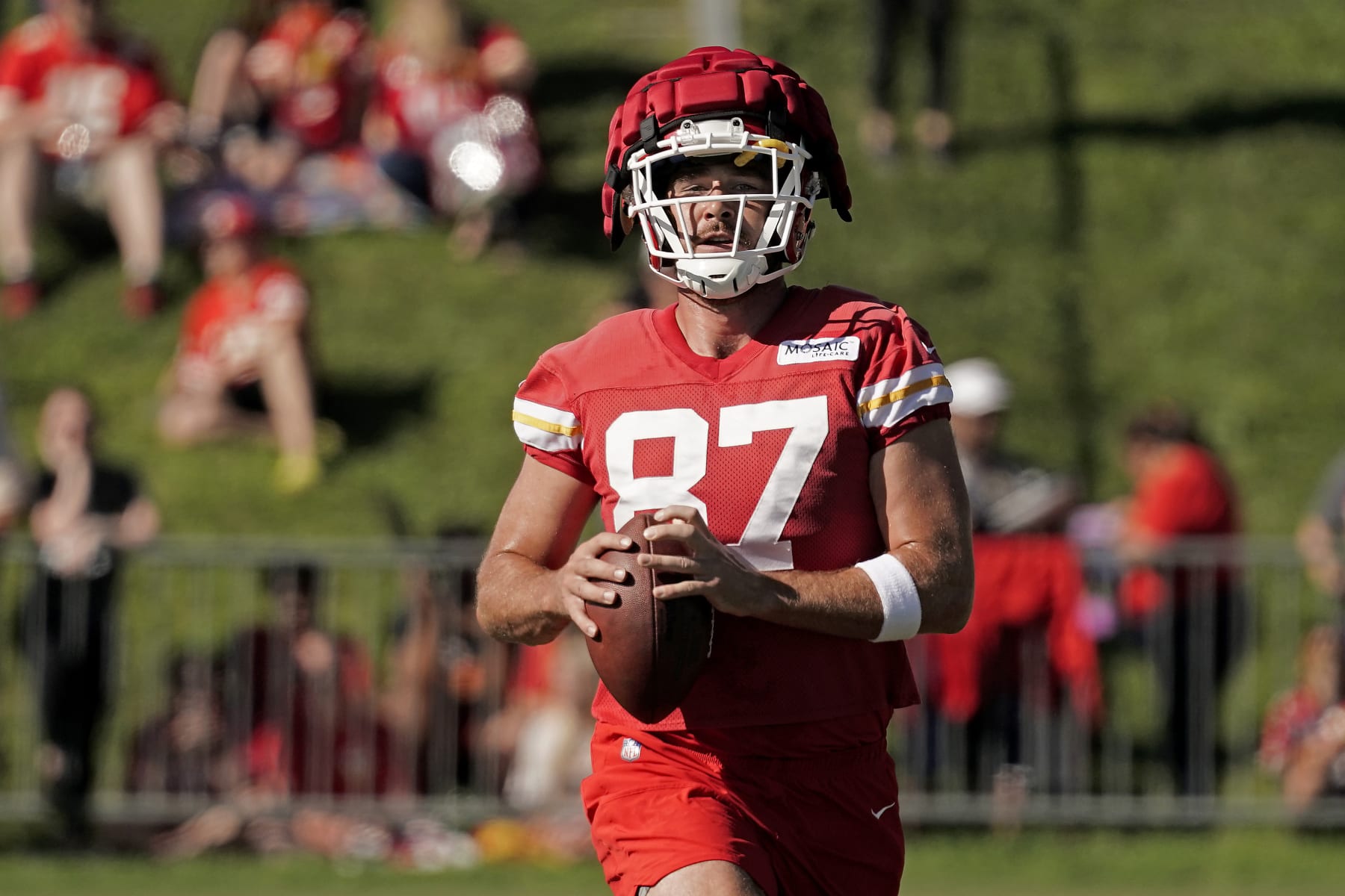 Kansas City Chiefs tight end Travis Kelce runs the ball at NFL football training camp Saturday, July 30, 2022, in St. Joseph, Mo. (AP Photo/Charlie Riedel)