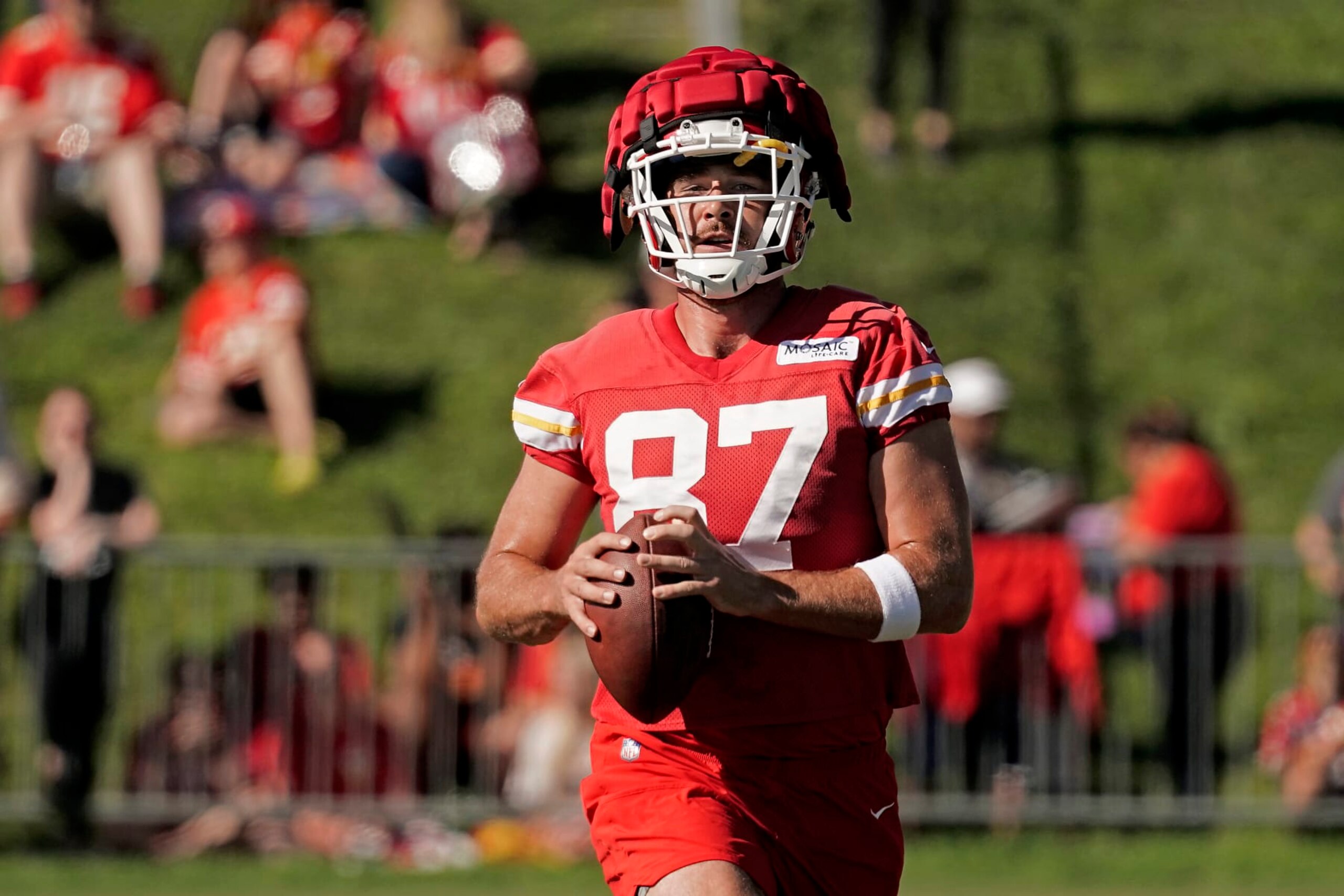 Kansas City Chiefs tight end Travis Kelce runs the ball at NFL football training camp Saturday, July 30, 2022, in St. Joseph, Mo. (AP Photo/Charlie Riedel)
