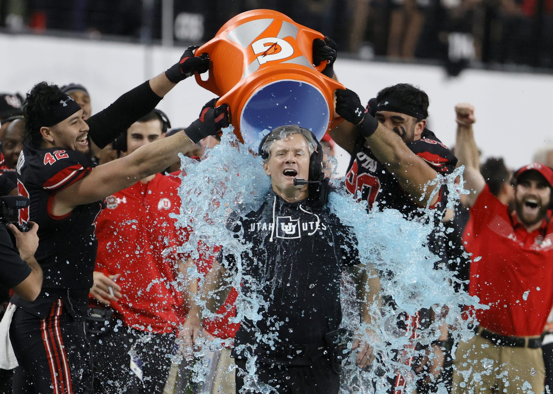 LAS VEGAS, NEVADA - DECEMBER 03:  Defensive end Mika Tafua #42 and defensive tackle Devin Kaufusi #90 of the Utah Utes dump Gatorade on their head coach Kyle Whittingham late in the Pac-12 Conference championship game against the Oregon Ducks at Allegiant Stadium on December 3, 2021 in Las Vegas, Nevada. The Utes defeated the Ducks 38-10.  (Photo by Ethan Miller/Getty Images)