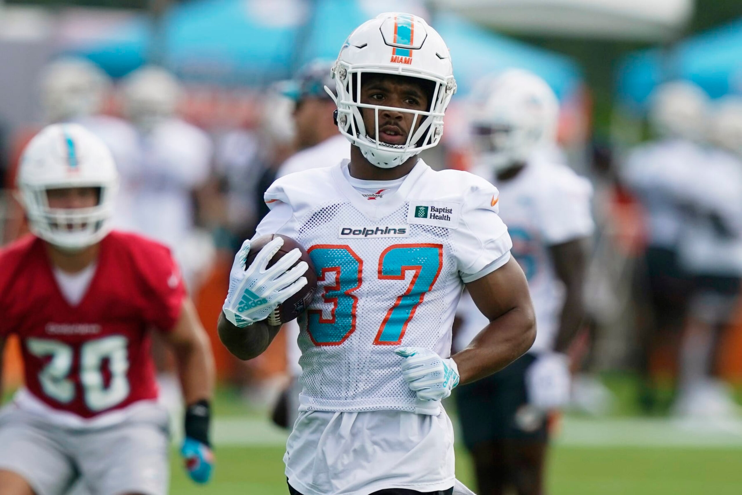 Miami Dolphins running back Myles Gaskin (37) takes part in drills at the NFL football team's practice facility, Saturday, July 30, 2022, in Miami Gardens, Fla. (AP Photo/Marta Lavandier)