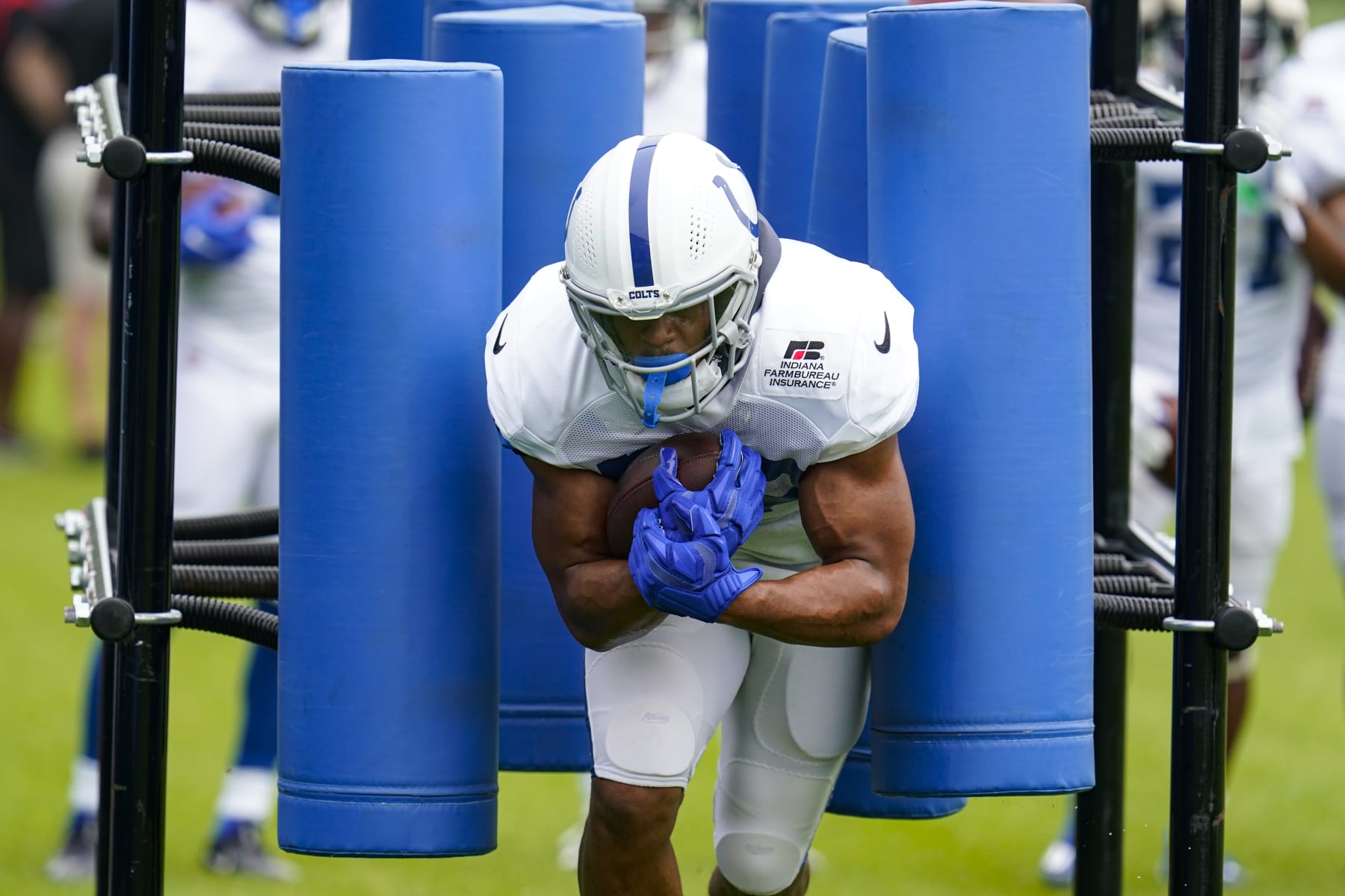 Indianapolis Colts running back Jonathan Taylor (28) runs a drill during practice at the NFL team's football training camp in Westfield, Ind., Tuesday, Aug. 2, 2022. (AP Photo/Michael Conroy)