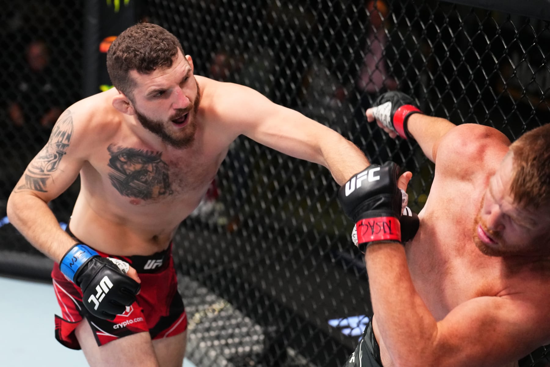 LAS VEGAS, NEVADA - AUGUST 06: (L-R) Michal Oleksiejczuk of Poland punches Sam Alvey in a middleweight fight during the UFC Fight Night event at UFC APEX on August 06, 2022 in Las Vegas, Nevada. (Photo by Chris Unger/Zuffa LLC)