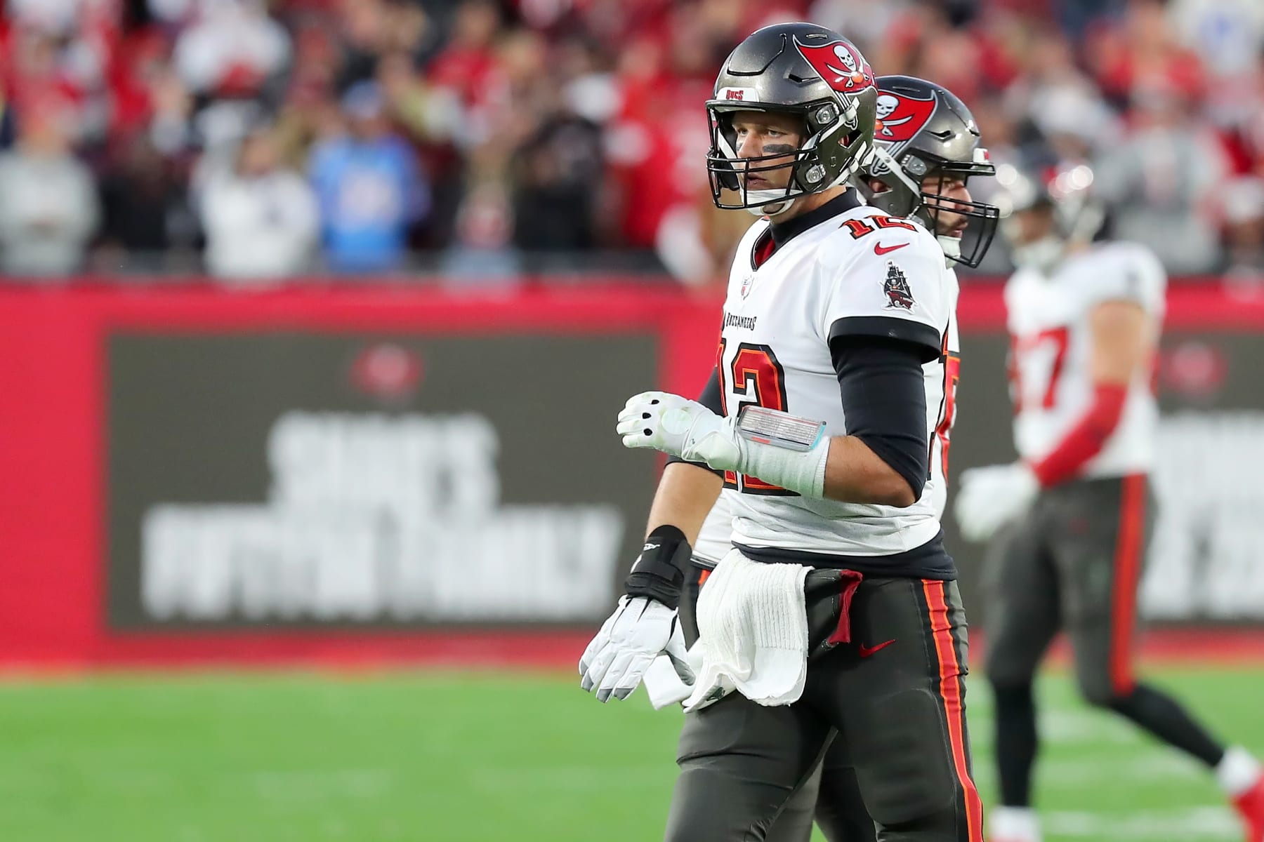 TAMPA, FL - JANUARY 23: Tampa Bay Buccaneers Quarterback Tom Brady (12) trots off the field after throwing the final touchdown of this career during the NFC Divisional game between the Los Angeles Rams and the Tampa Bay Buccaneers on January 23, 2022 at Raymond James Stadium in Tampa, Florida. (Photo by Cliff Welch/Icon Sportswire via Getty Images)